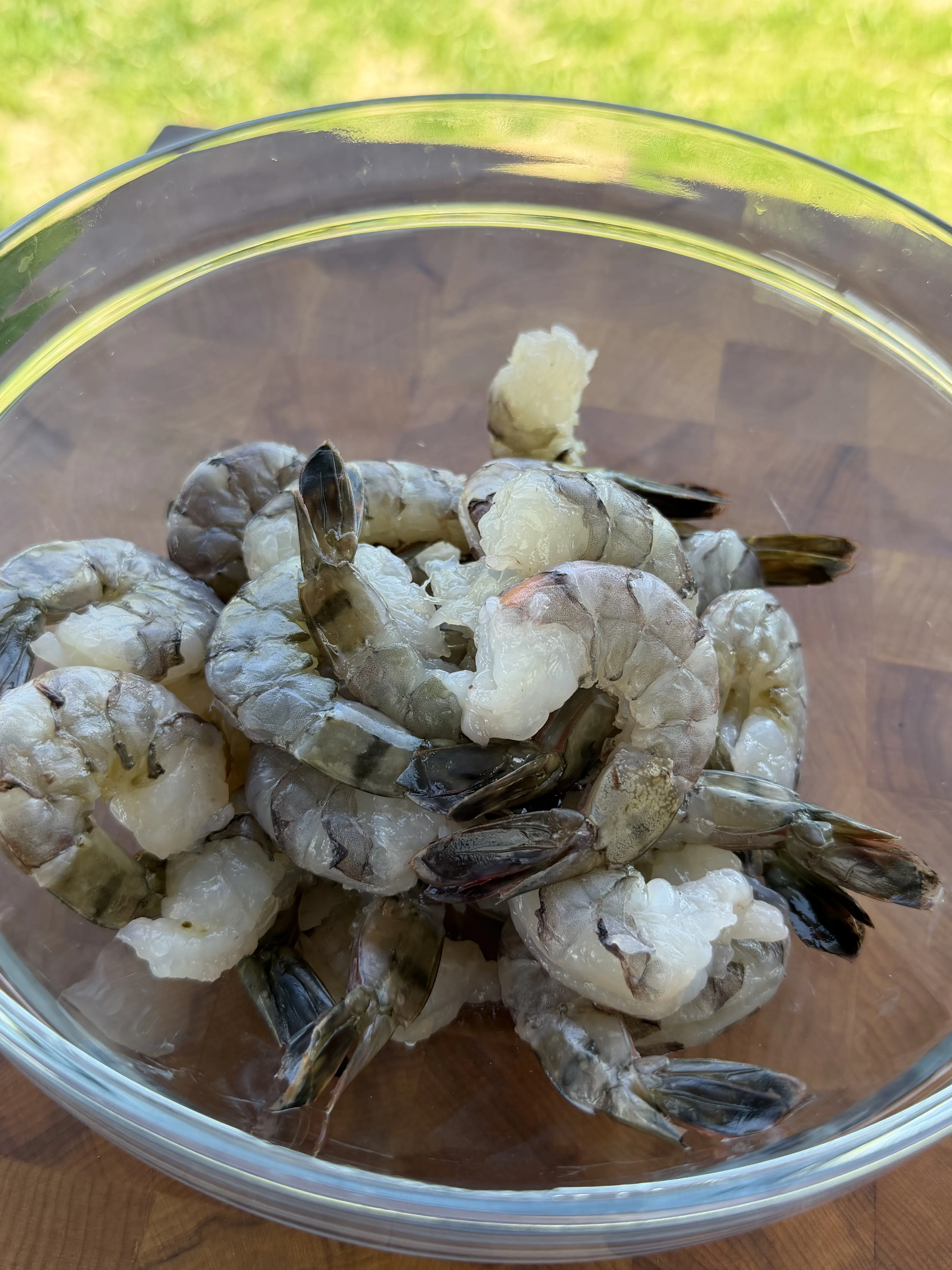 Raw shrimp in a glass bowl ready for smoking preparation