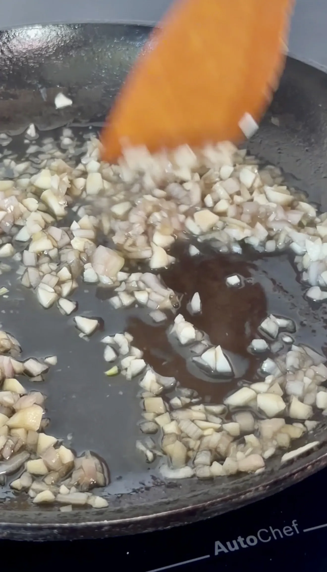 Sauteed shallots cooking in whiskey butter sauce pan