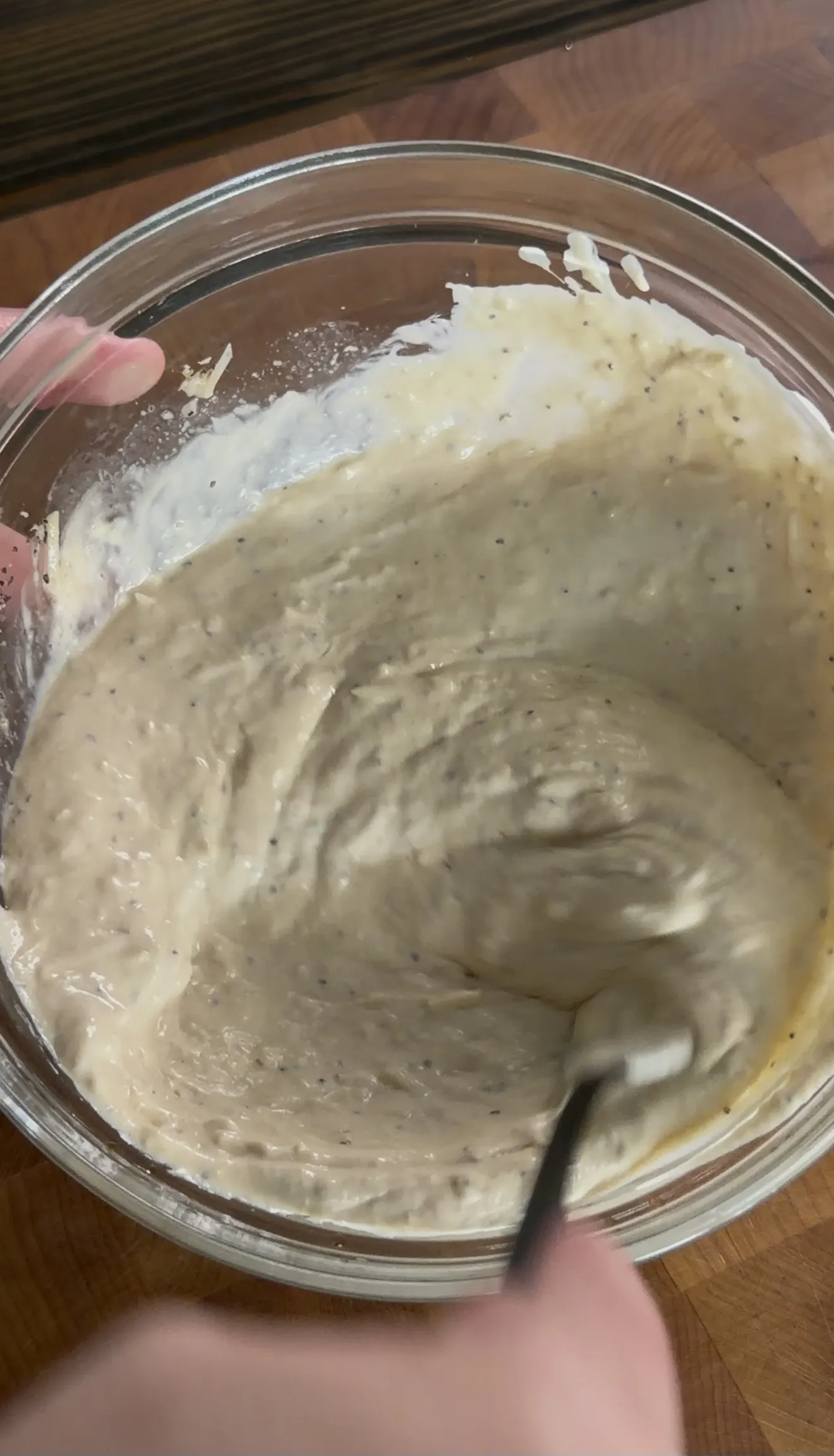 Homemade Caesar dressing being prepared in a mixing bowl