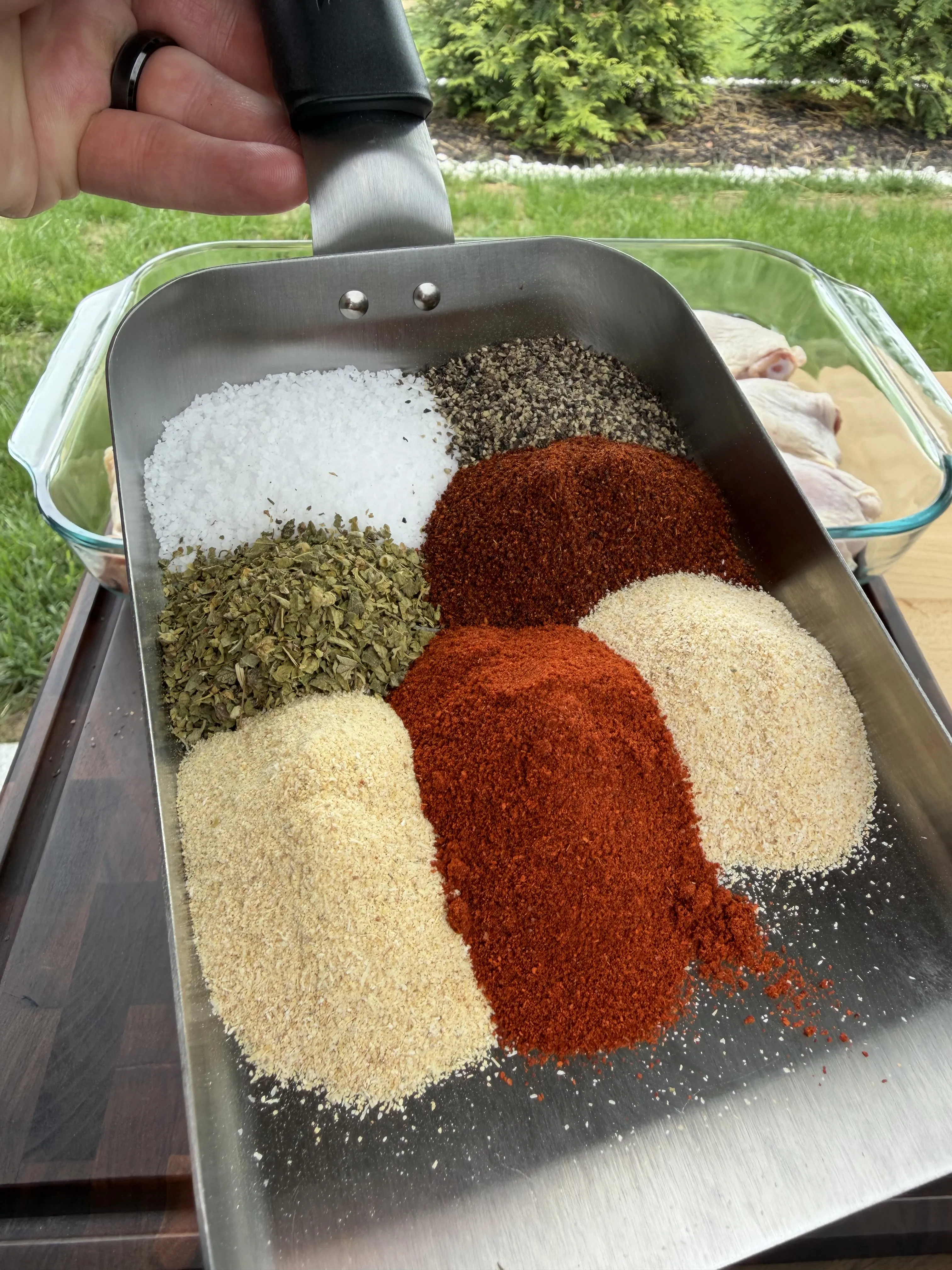 Chicken seasoning blend with paprika, garlic powder, salt, and pepper in a glass bowl