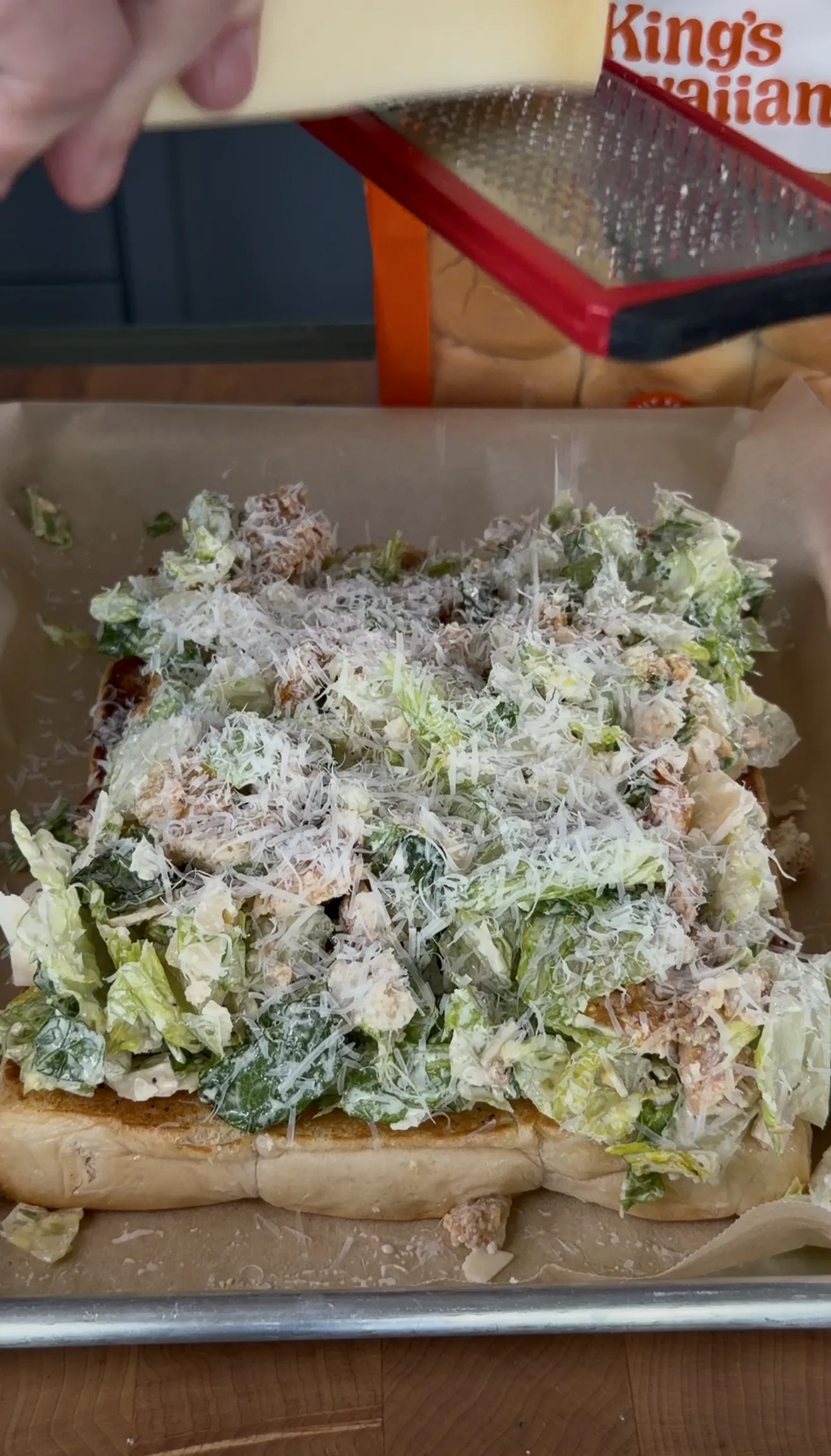 Crispy chicken caesar sliders topped with freshly grated parmesan cheese