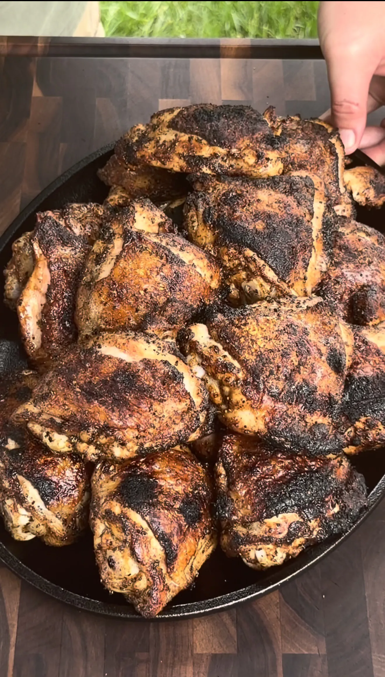 Crispy grilled garlic parmesan chicken thighs finished with melted parmesan in a cast iron skillet