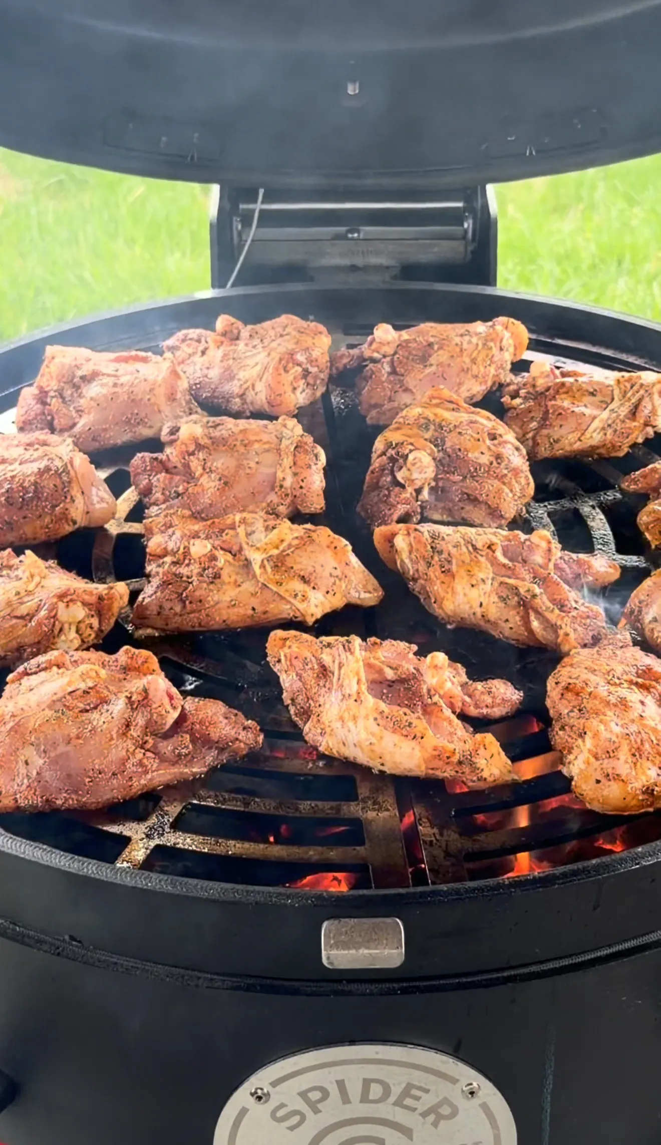 Bone-in chicken thighs grilling on a Weber kettle with two-zone setup