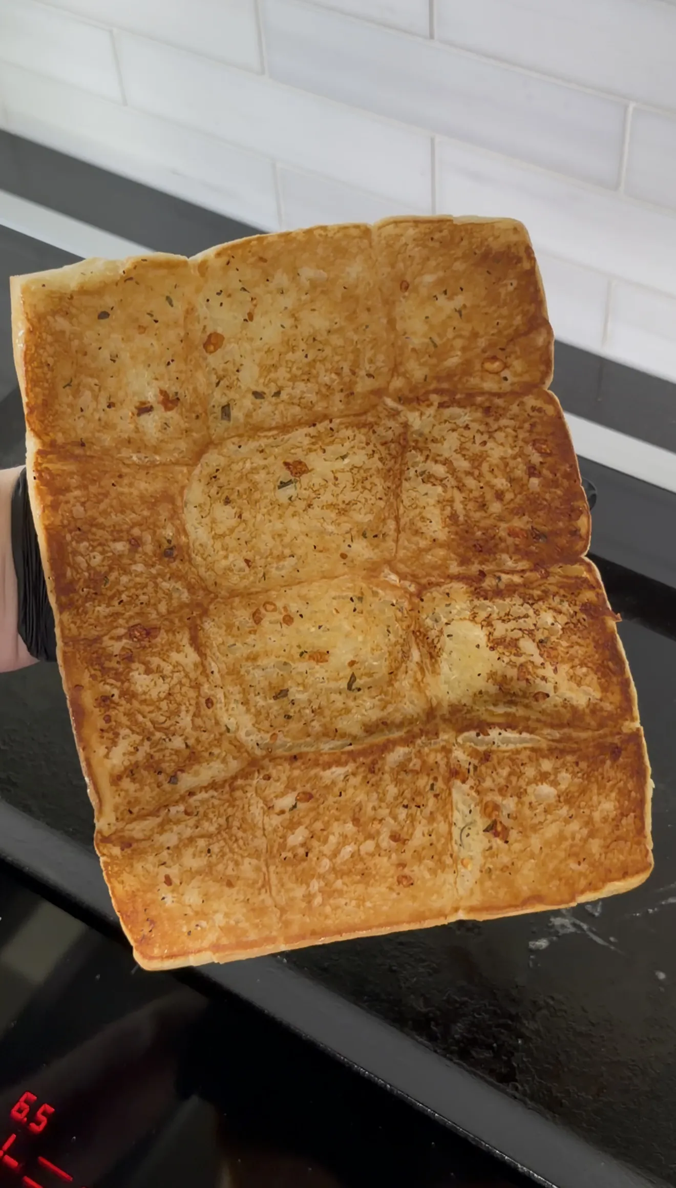 Golden toasted slider buns on a griddle for chicken caesar sliders