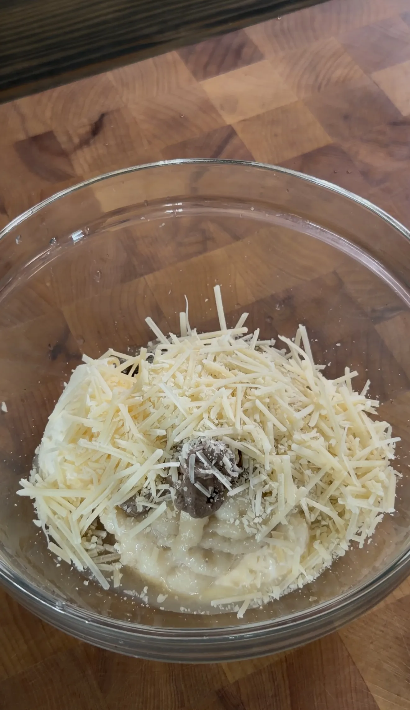 Freshly grated parmesan cheese added to homemade Caesar dressing