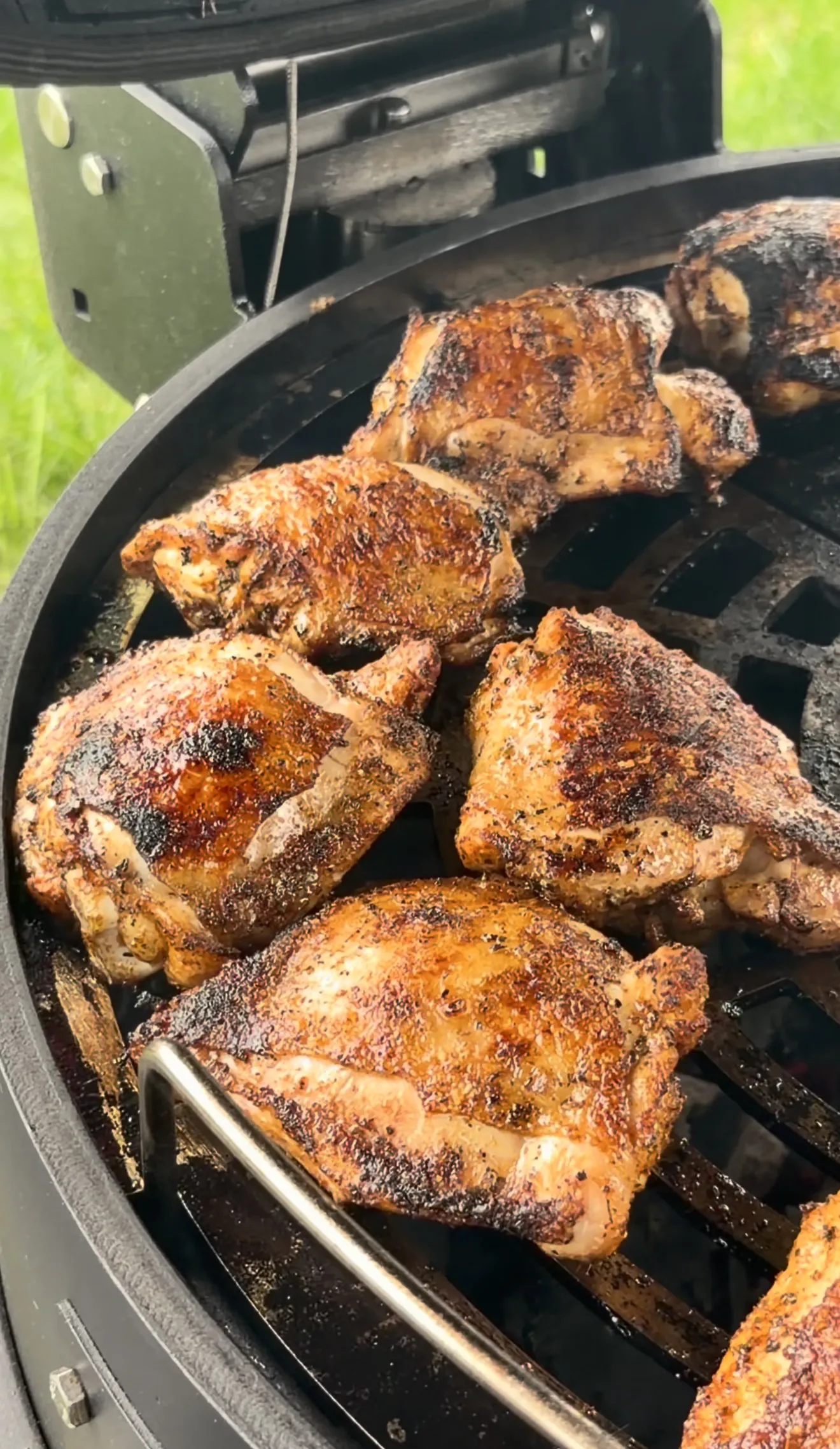 Garlic parmesan grilled chicken thighs finishing on the indirect side of a two-zone grill