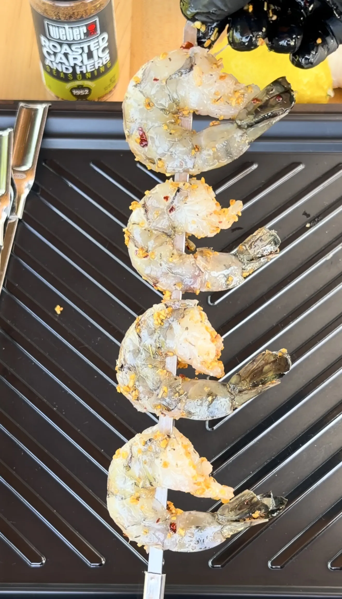 Large grilled shrimp skewers with herbs and garlic on Weber grill grates