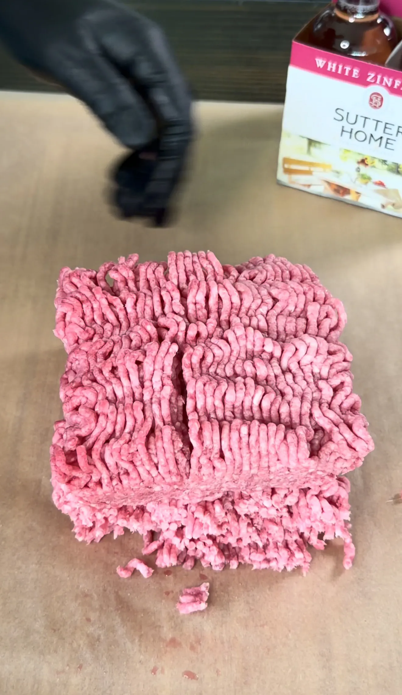 Raw ground beef formed into patties on cutting board for bacon jam smash burger preparation