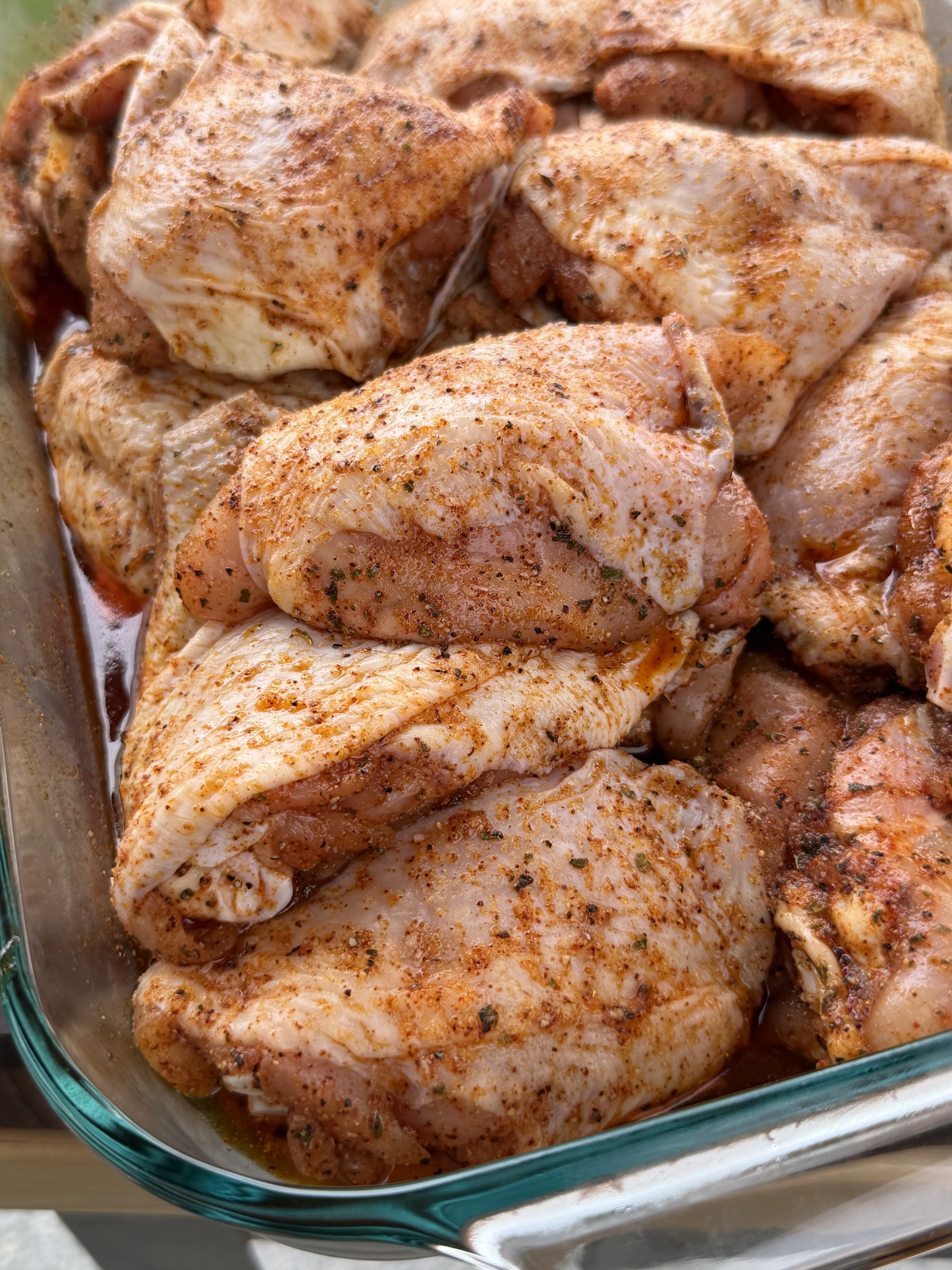 Seasoned chicken thighs air-chilling uncovered for crispy skin