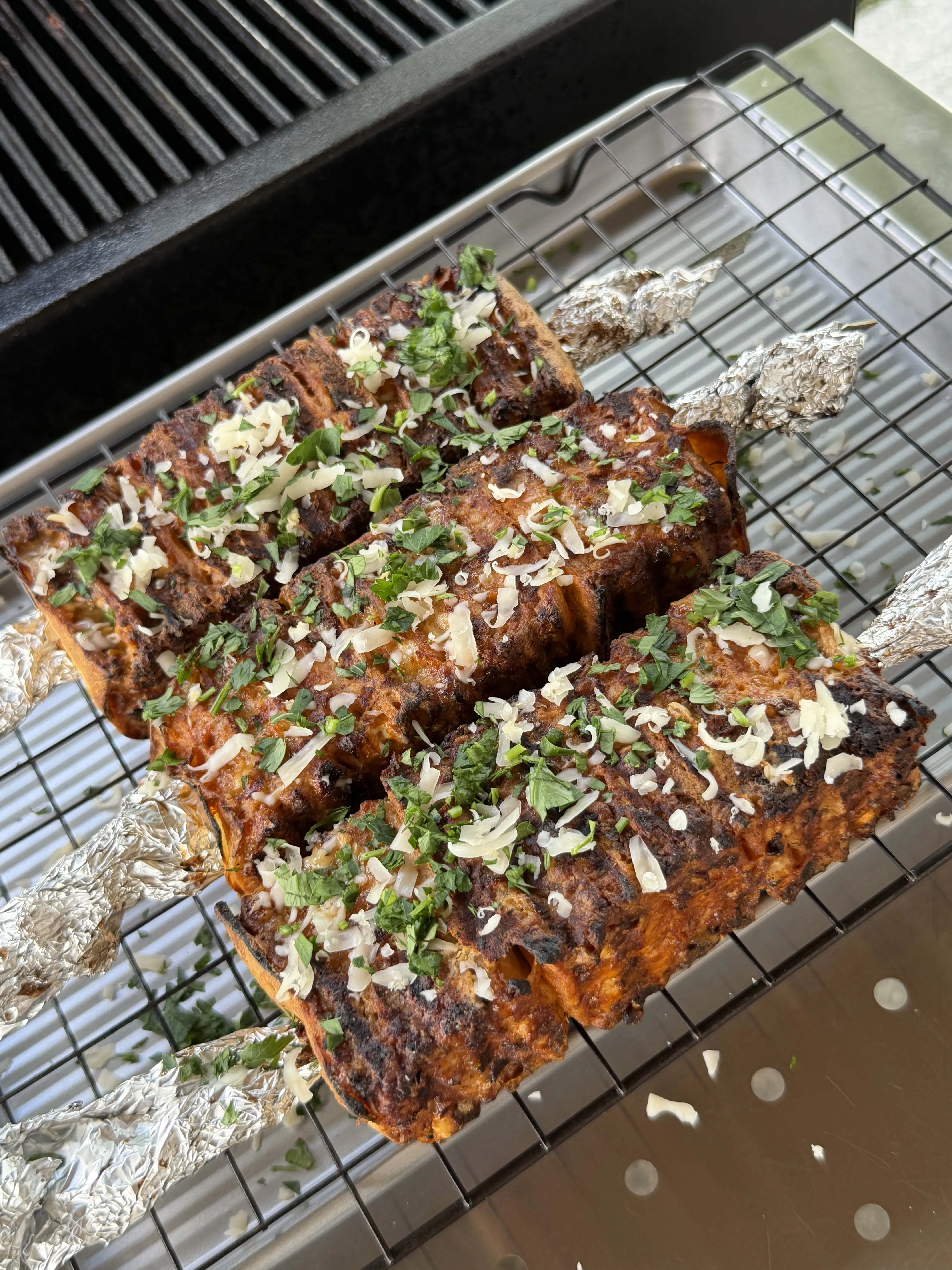 Grilled buffalo chicken tortilla kebabs topped with cheese and fresh herbs