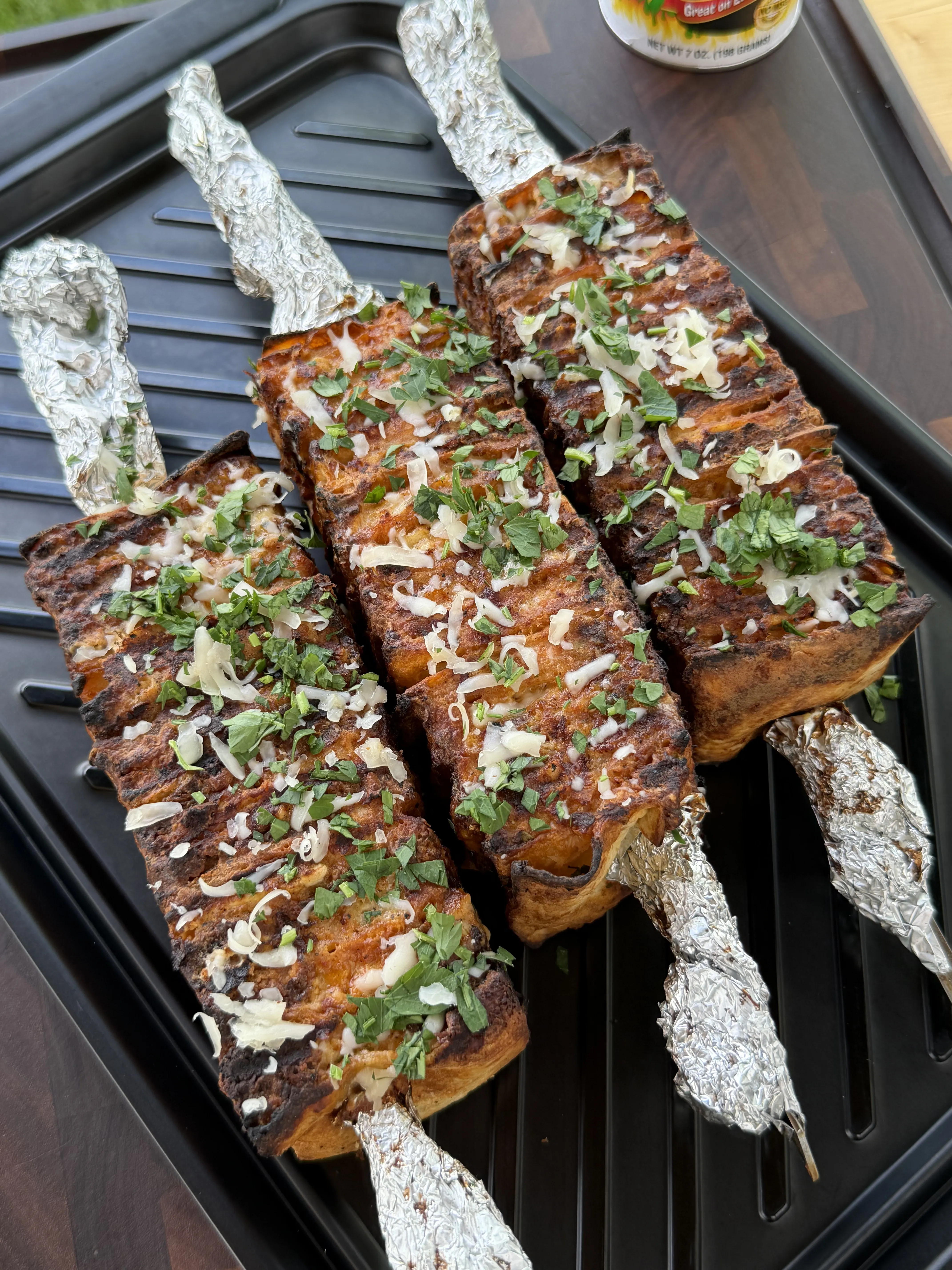 Finished buffalo chicken tortilla kebabs topped with cheese, ranch, and scallions