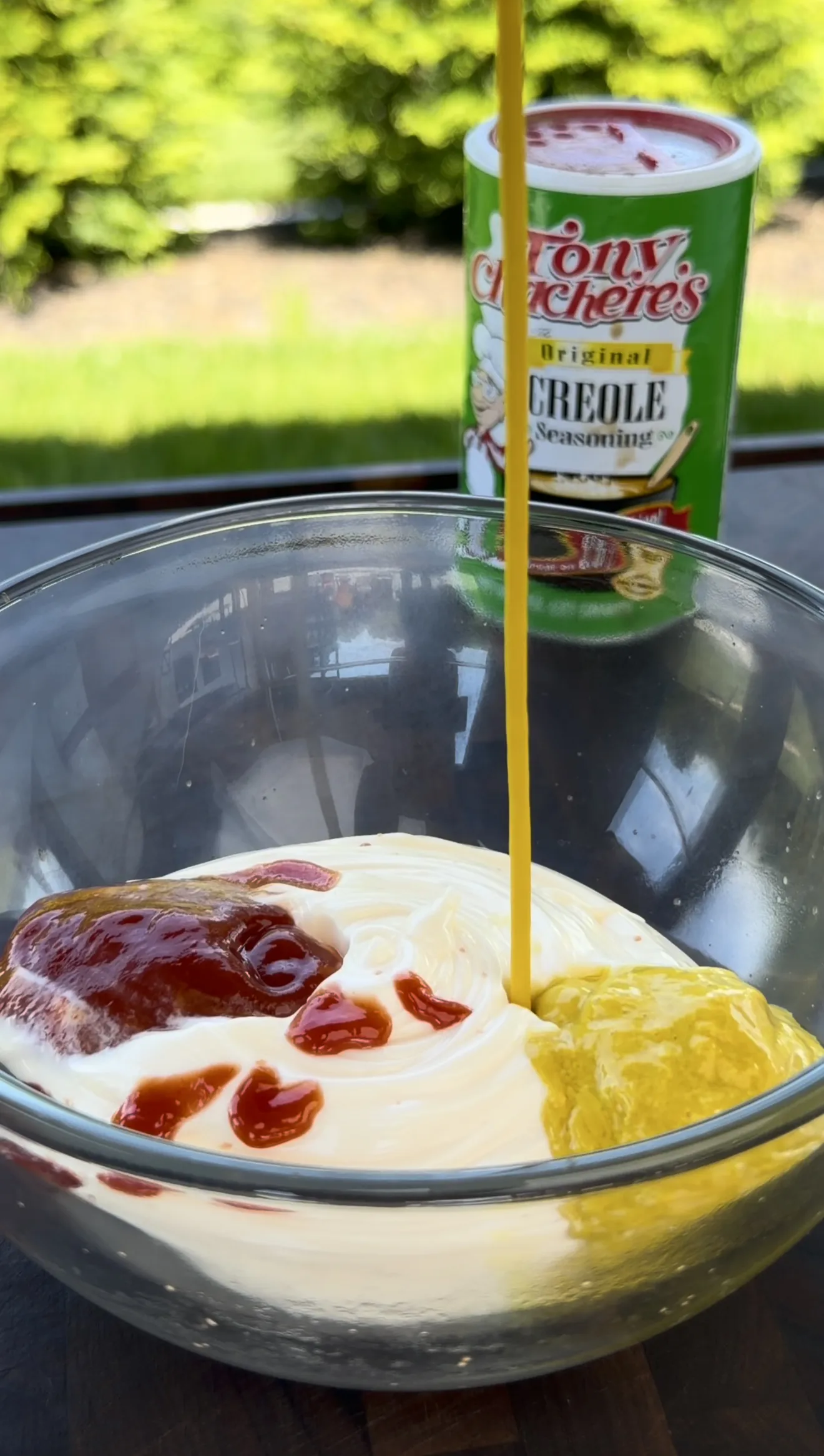 Cajun burger sauce ingredients of mayo, mustard, and ketchup in a glass bowl