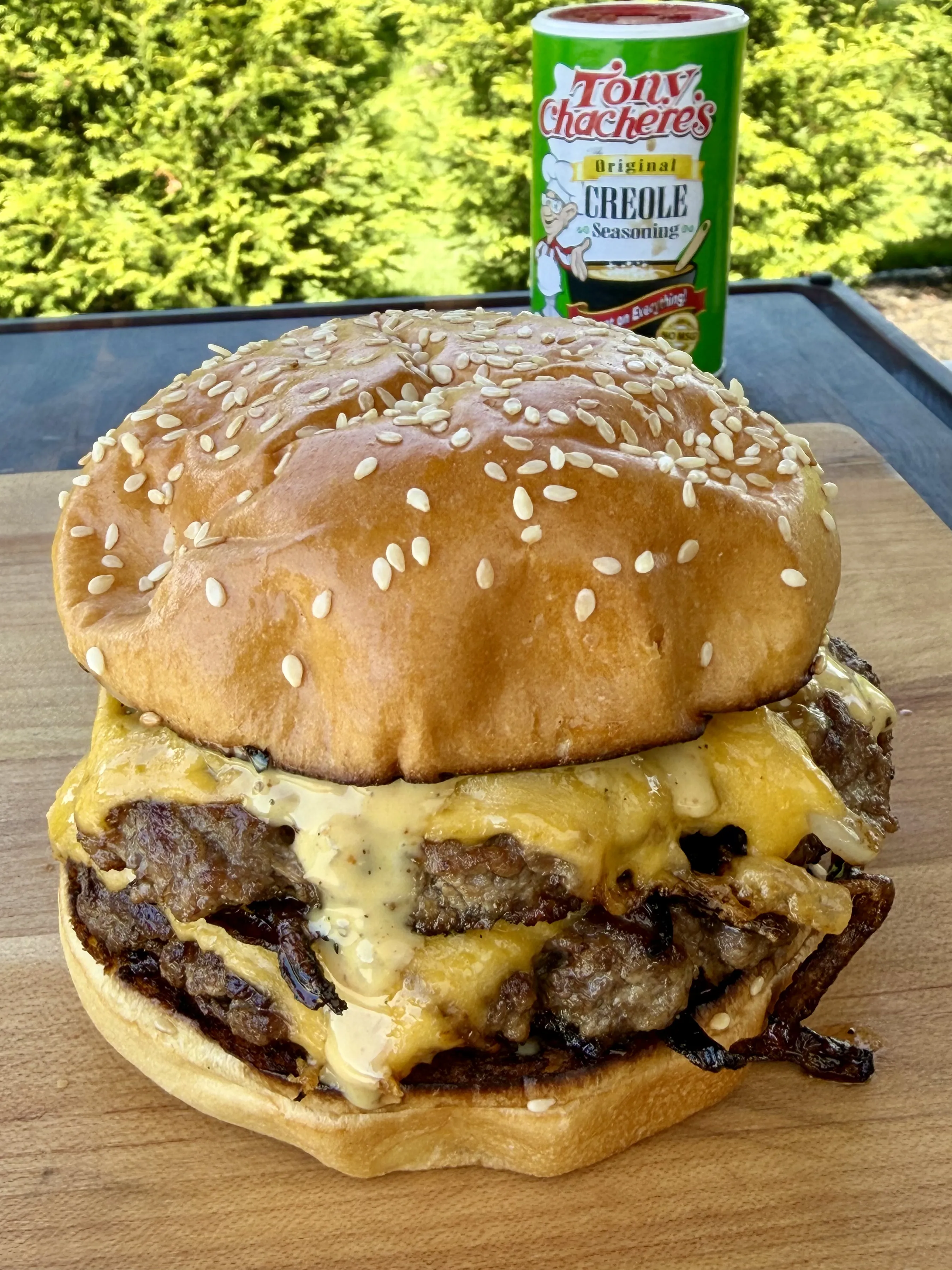 Stacked Cajun Oklahoma onion smash burgers with crispy onions and Cajun sauce