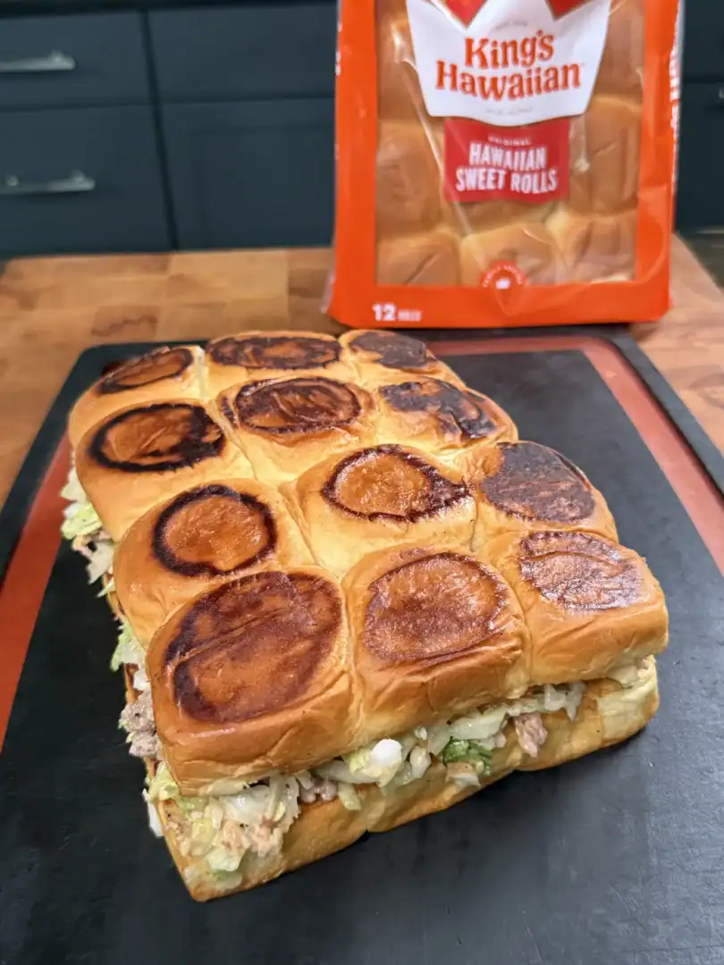 Toasted King's Hawaiian sweet roll sliders filled with chopped cheeseburger mixture on a slate board