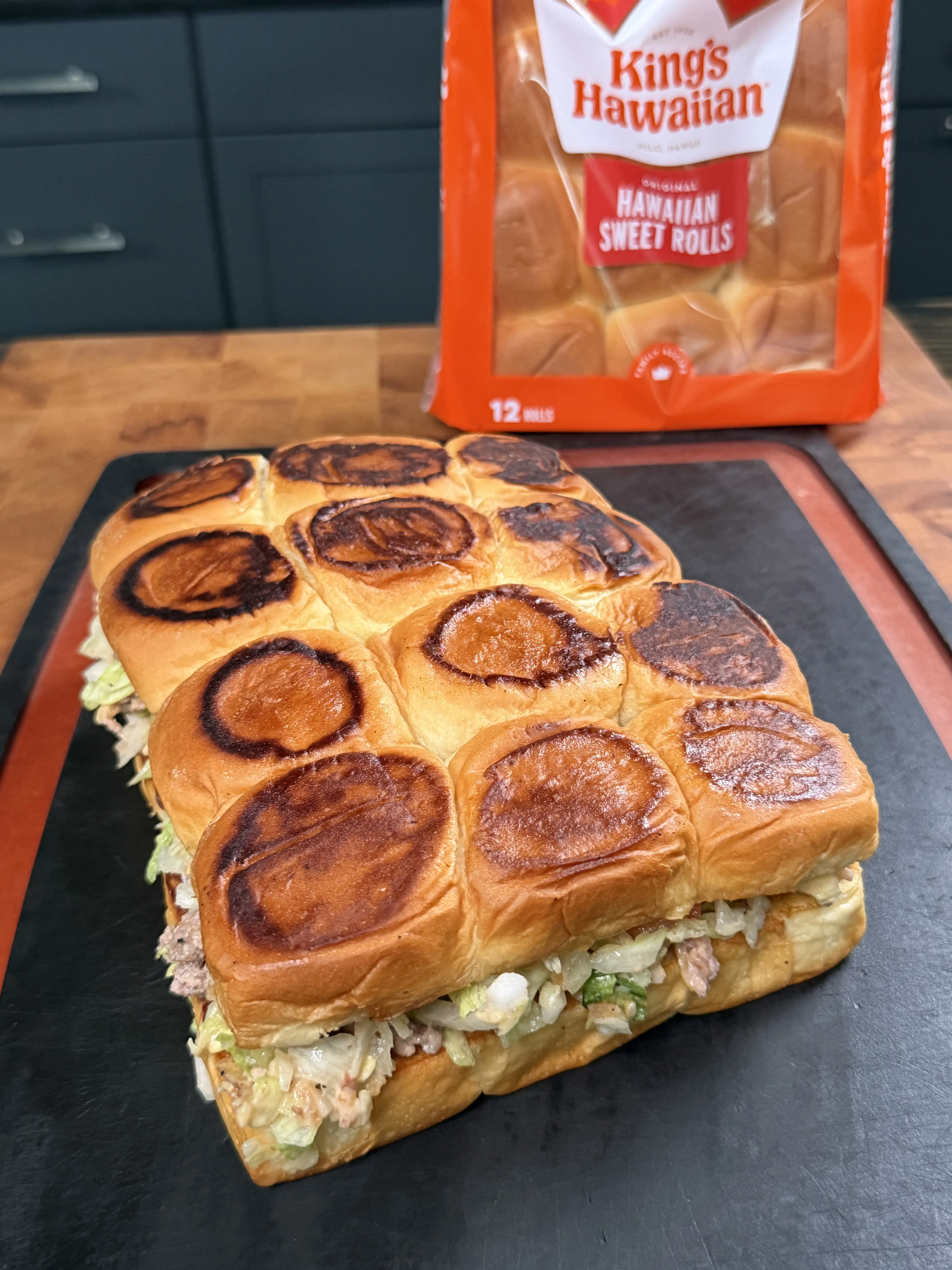 Chopped cheeseburger sliders on toasted King's Hawaiian rolls filled with beef, cheese, and toppings