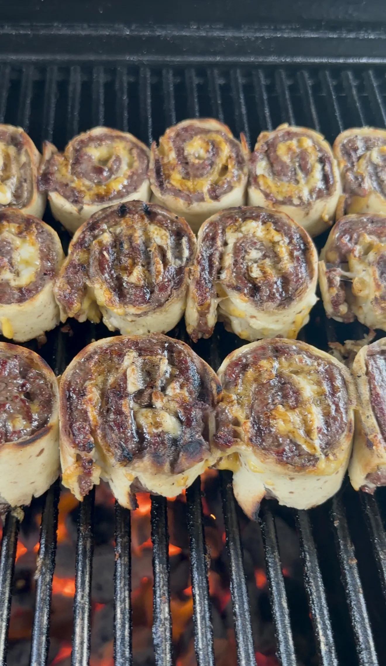 Cowboy butter beef tortilla pinwheels grilling with golden seared spiral tops