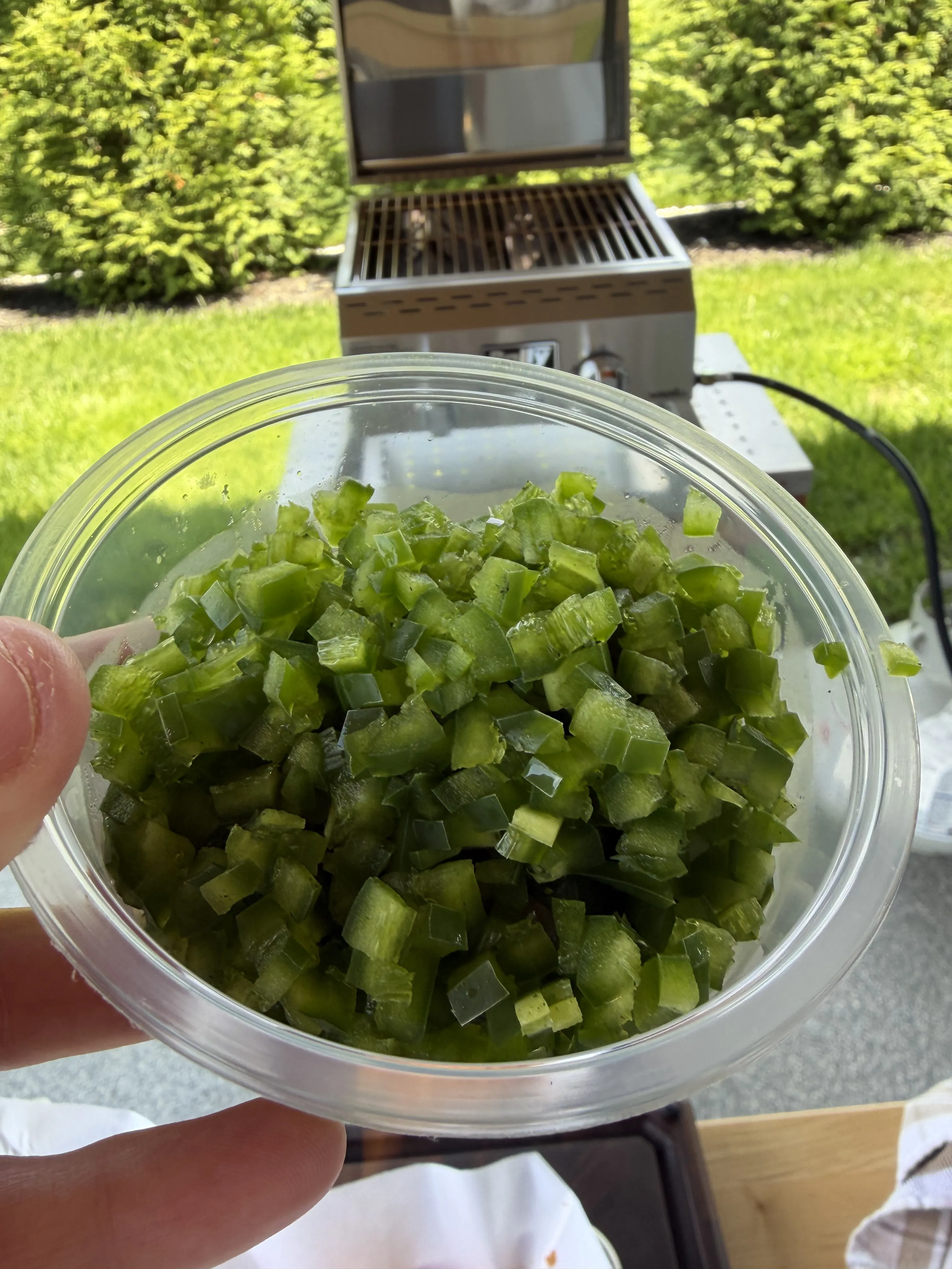 Freshly diced green jalapeños in a glass bowl ready for the beef pinwheel filling