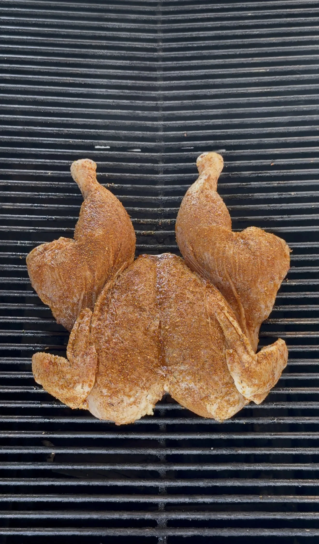 Lemon garlic herb spatchcock chicken with crispy golden skin on the grill grates