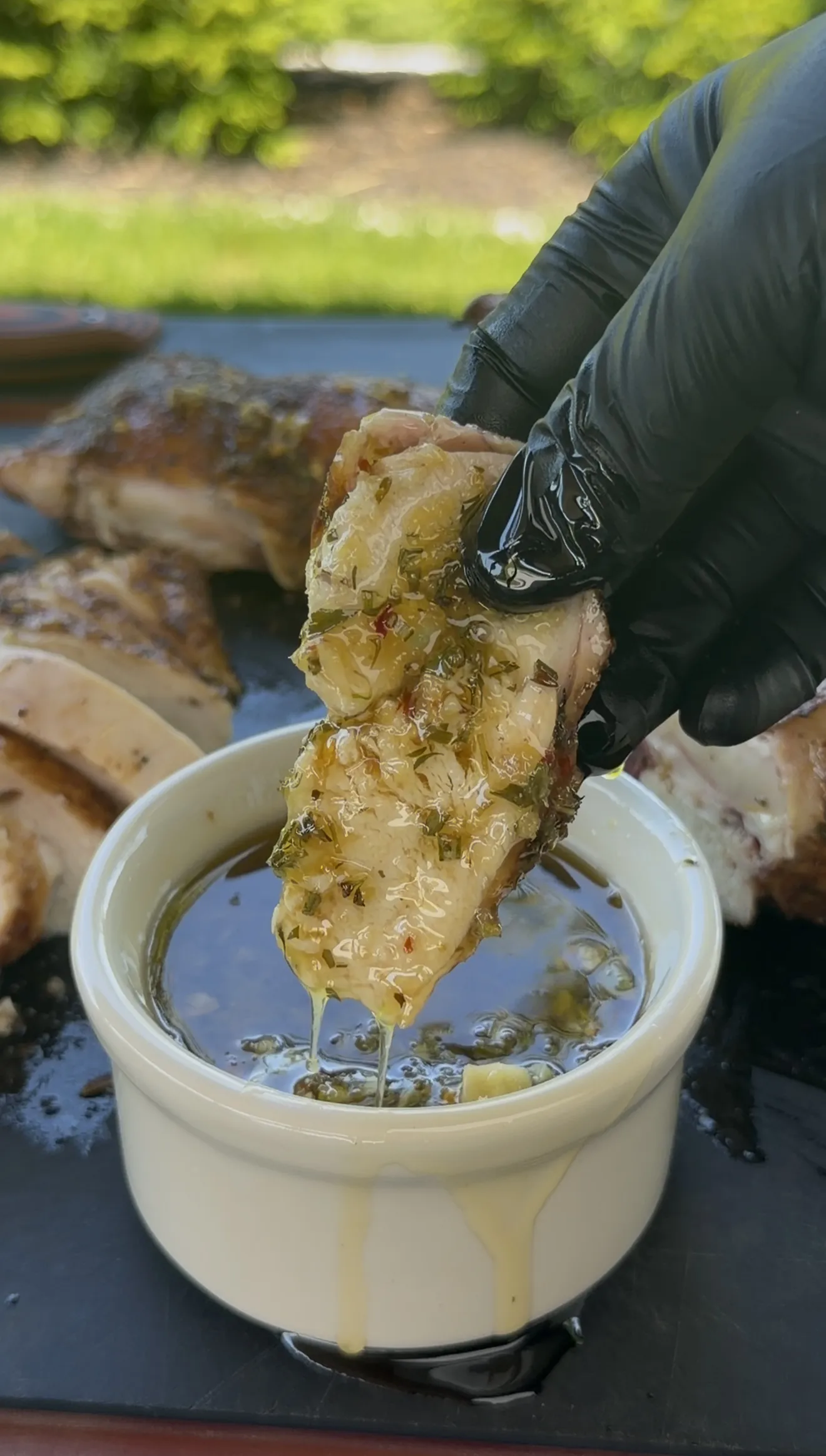 Herb butter juices dripping from the freshly grilled spatchcock chicken