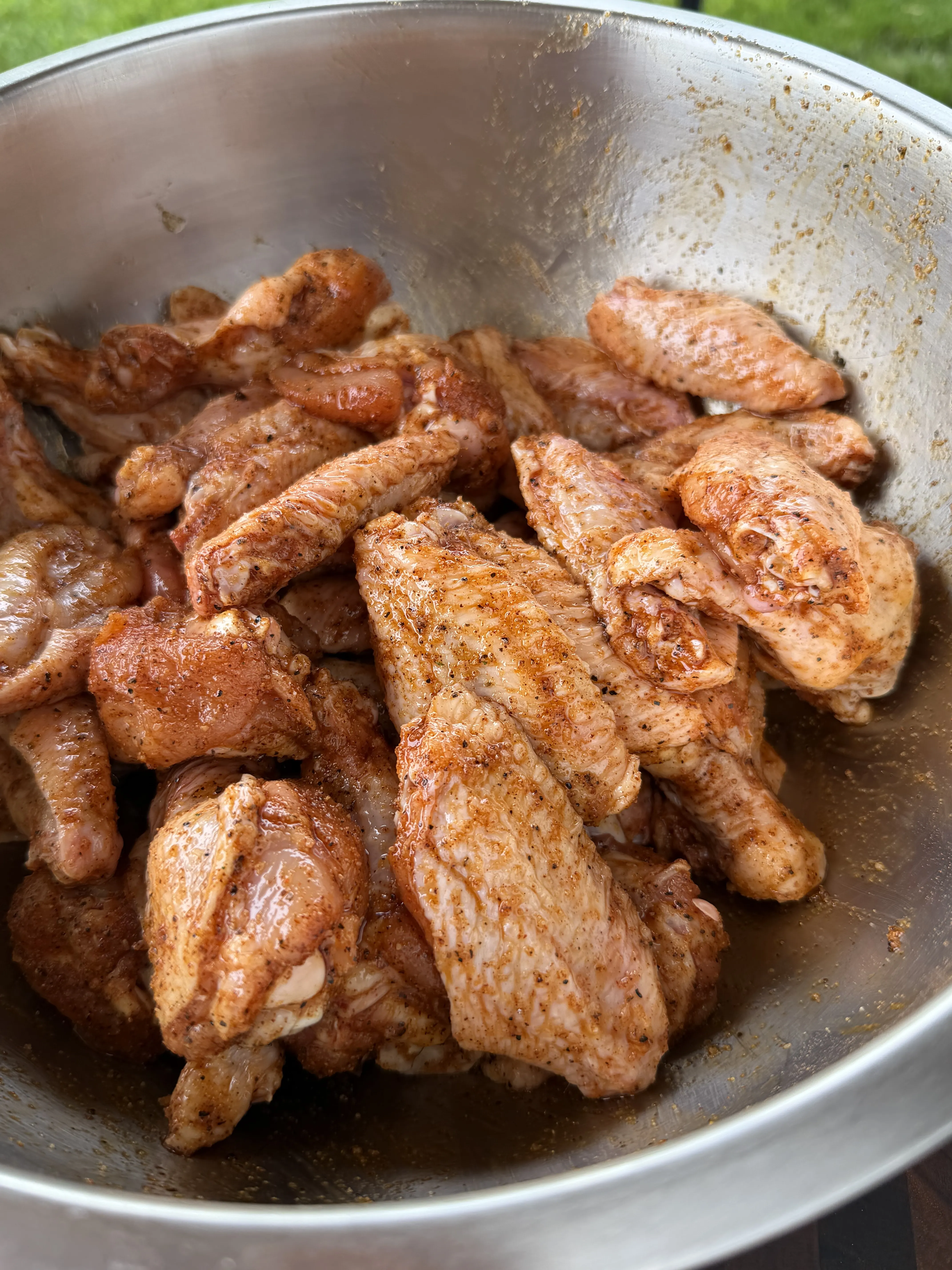 Seasoned lemon pepper wings starting their indirect cook on the grill