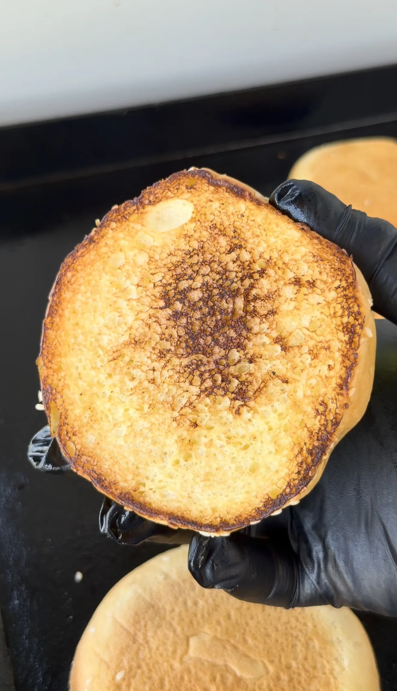 Buttered and toasted brioche bun for the Cajun Oklahoma onion smash burger