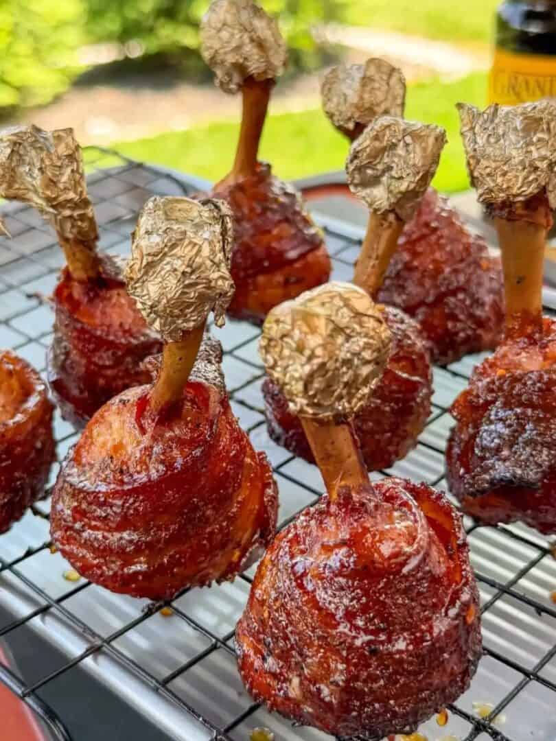 Bacon wrapped chicken lollipops with molasses glaze