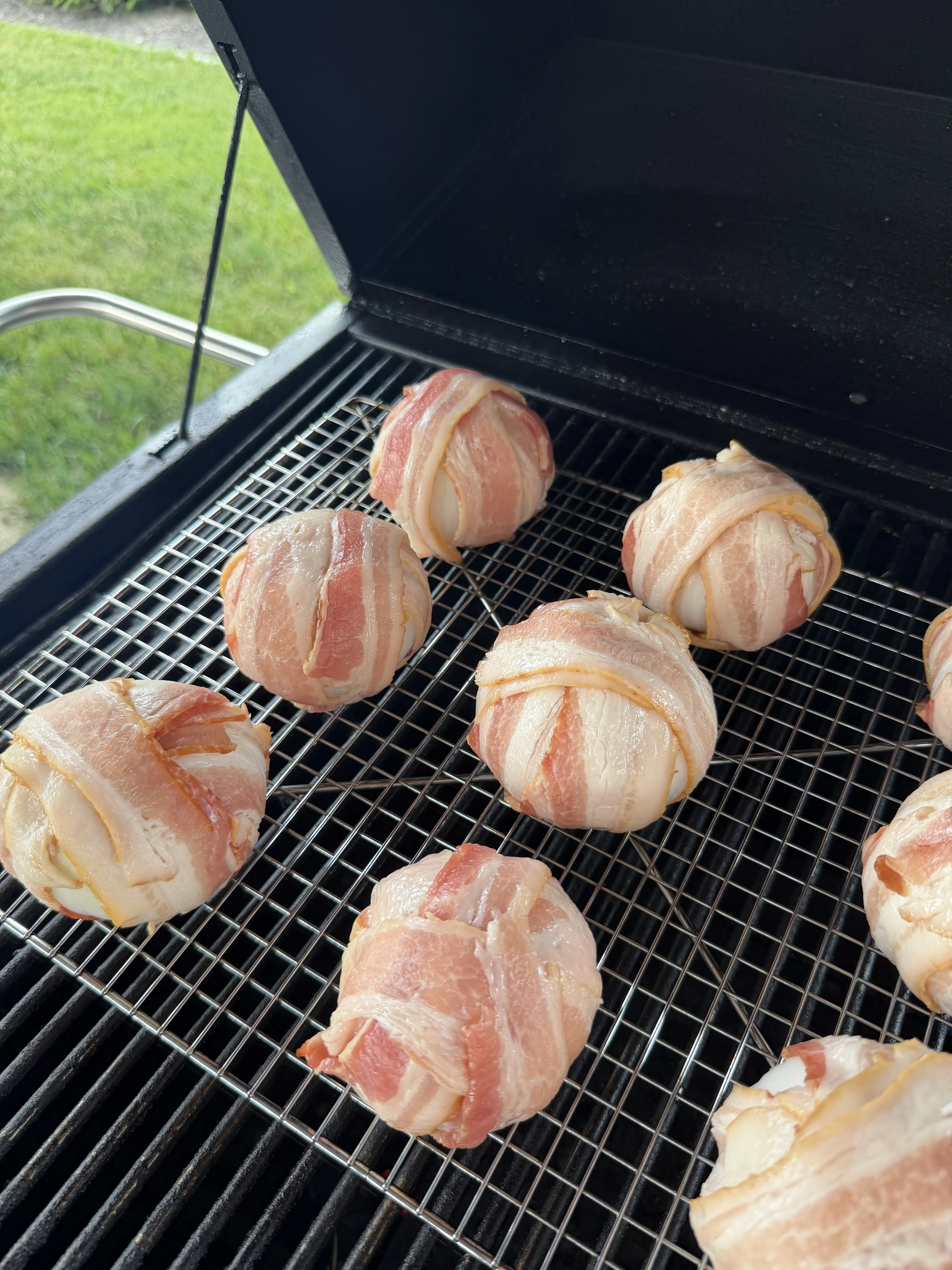 Onion bombs taking on smoke over the fire on a wire rack