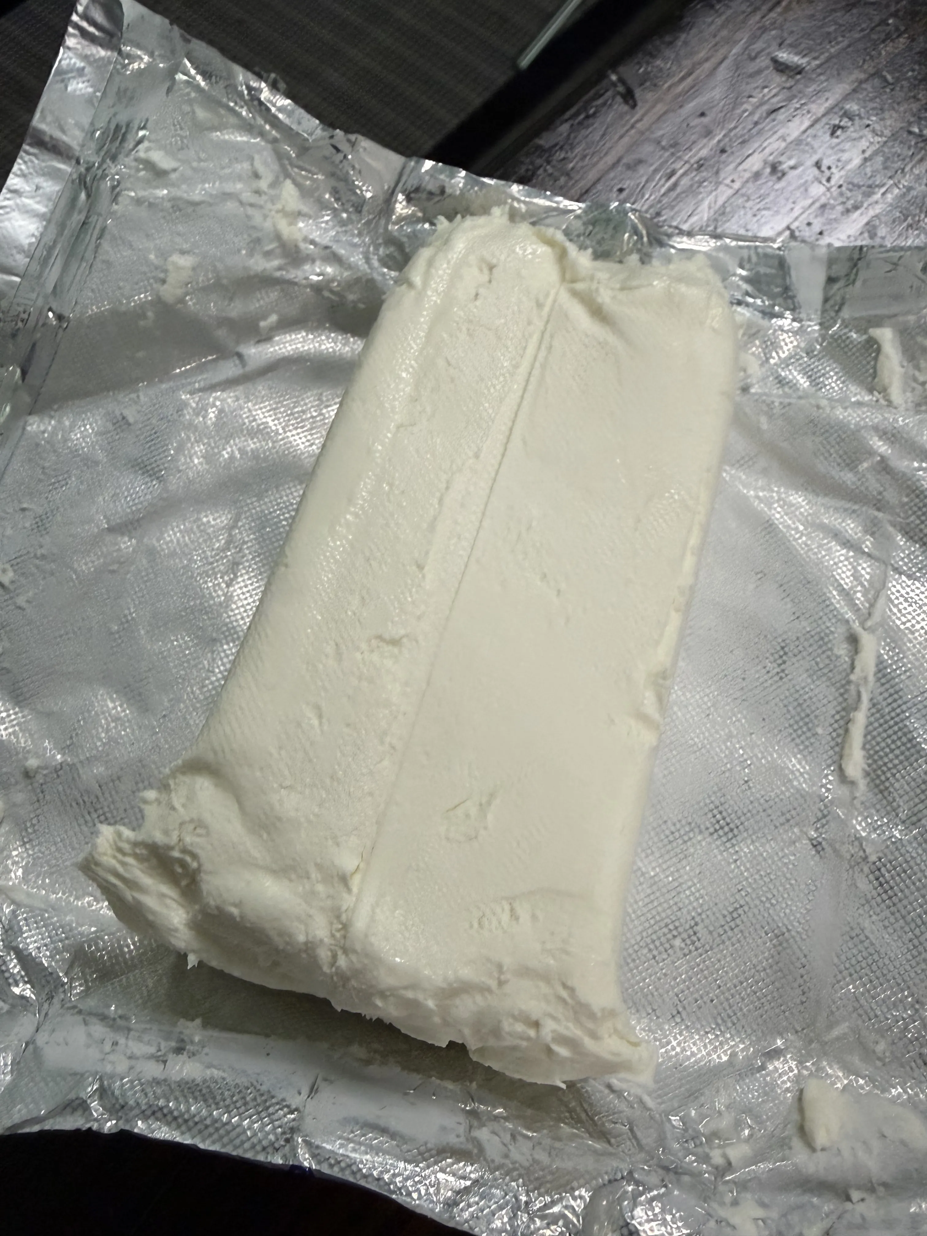 Block of cream cheese unwrapped for the jalapeño smokie bomb filling