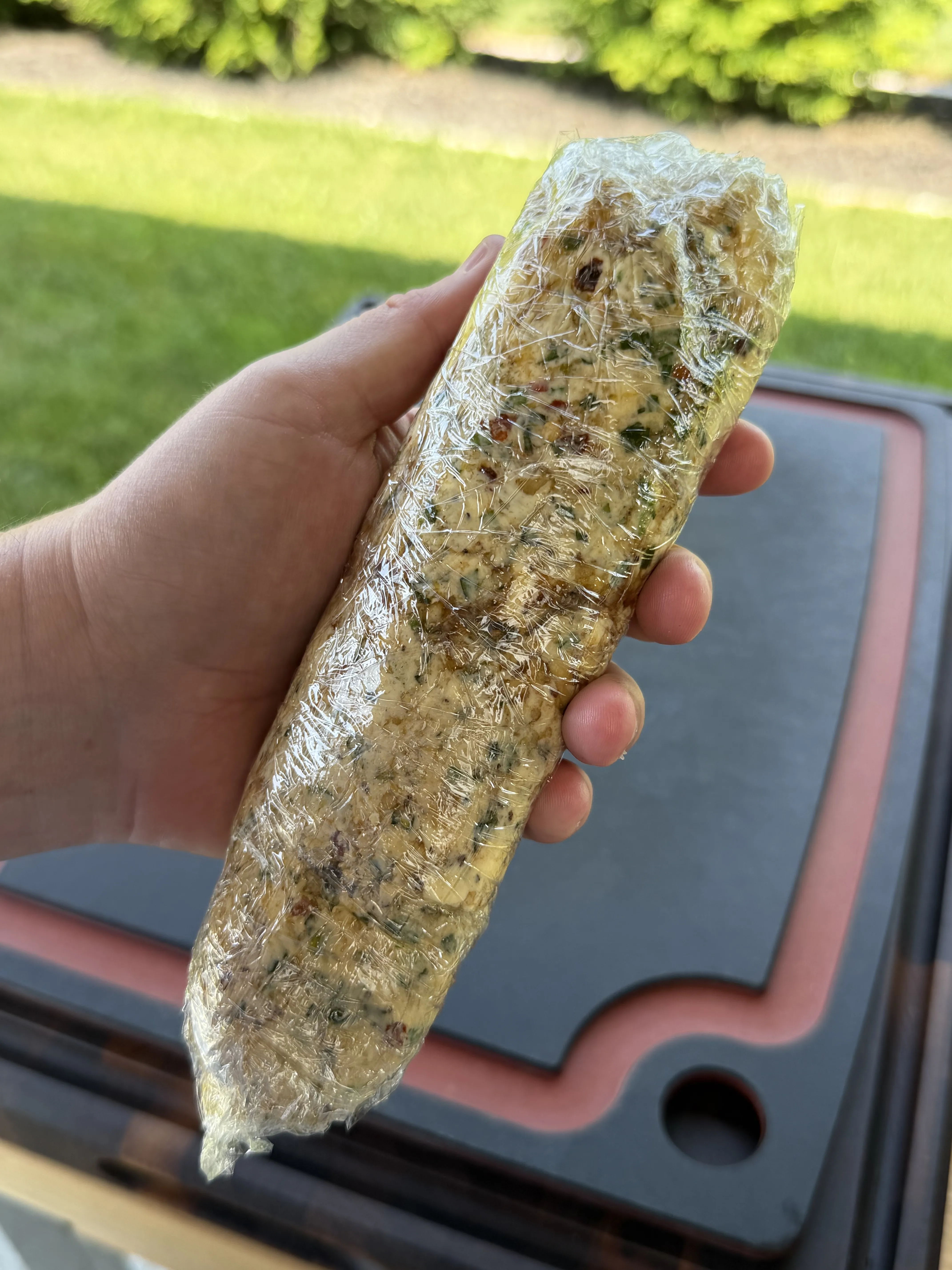Compound butter log rolled tight in plastic wrap and ready to chill