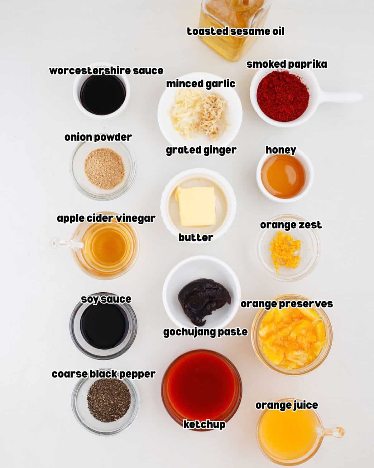 small bowls filled with ingredients for orange Gochujang sauce, placed on a flat surface.