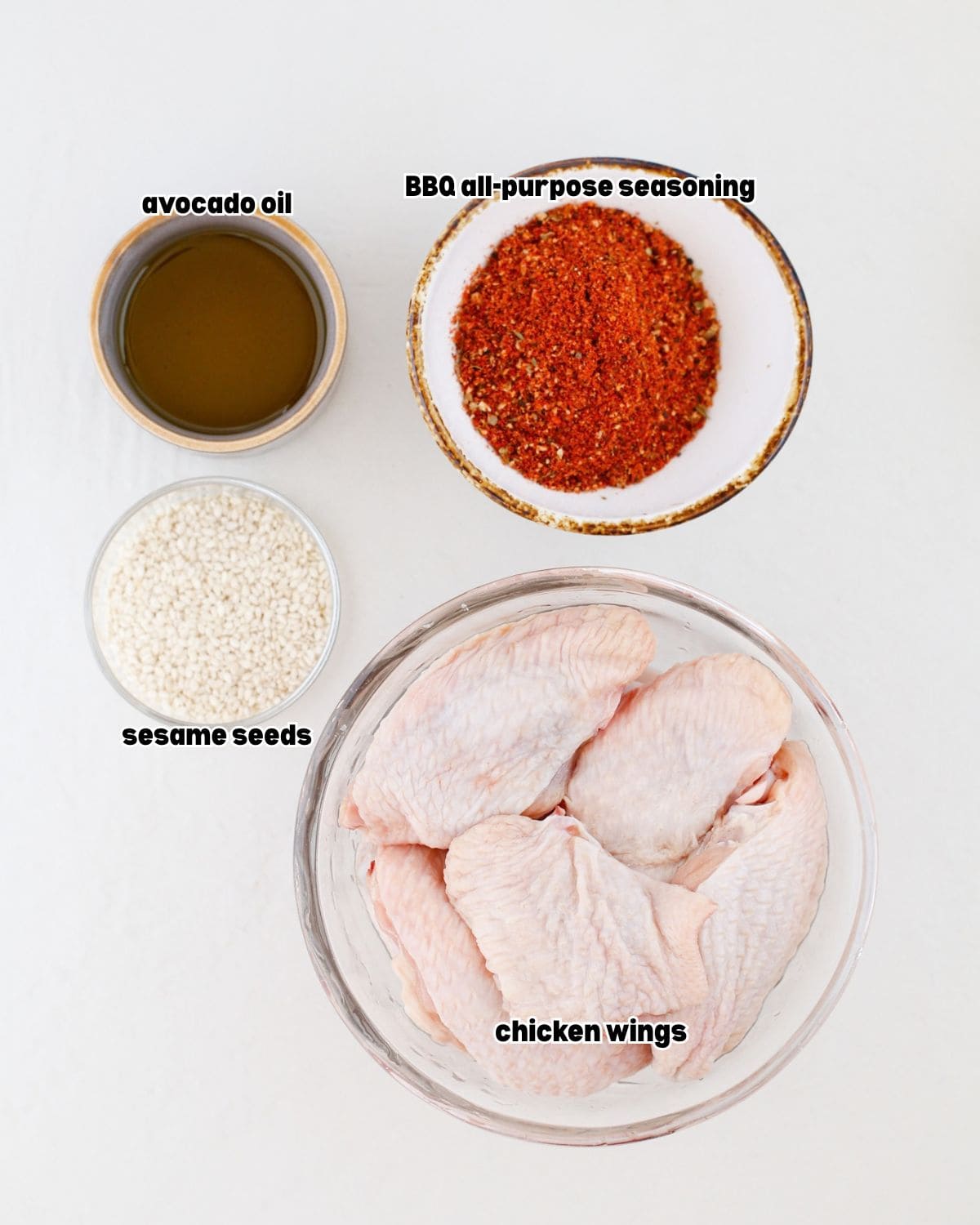 ingredients for orange Gochujang smoked chicken wings placed in bowls, on a kitchen countertop.