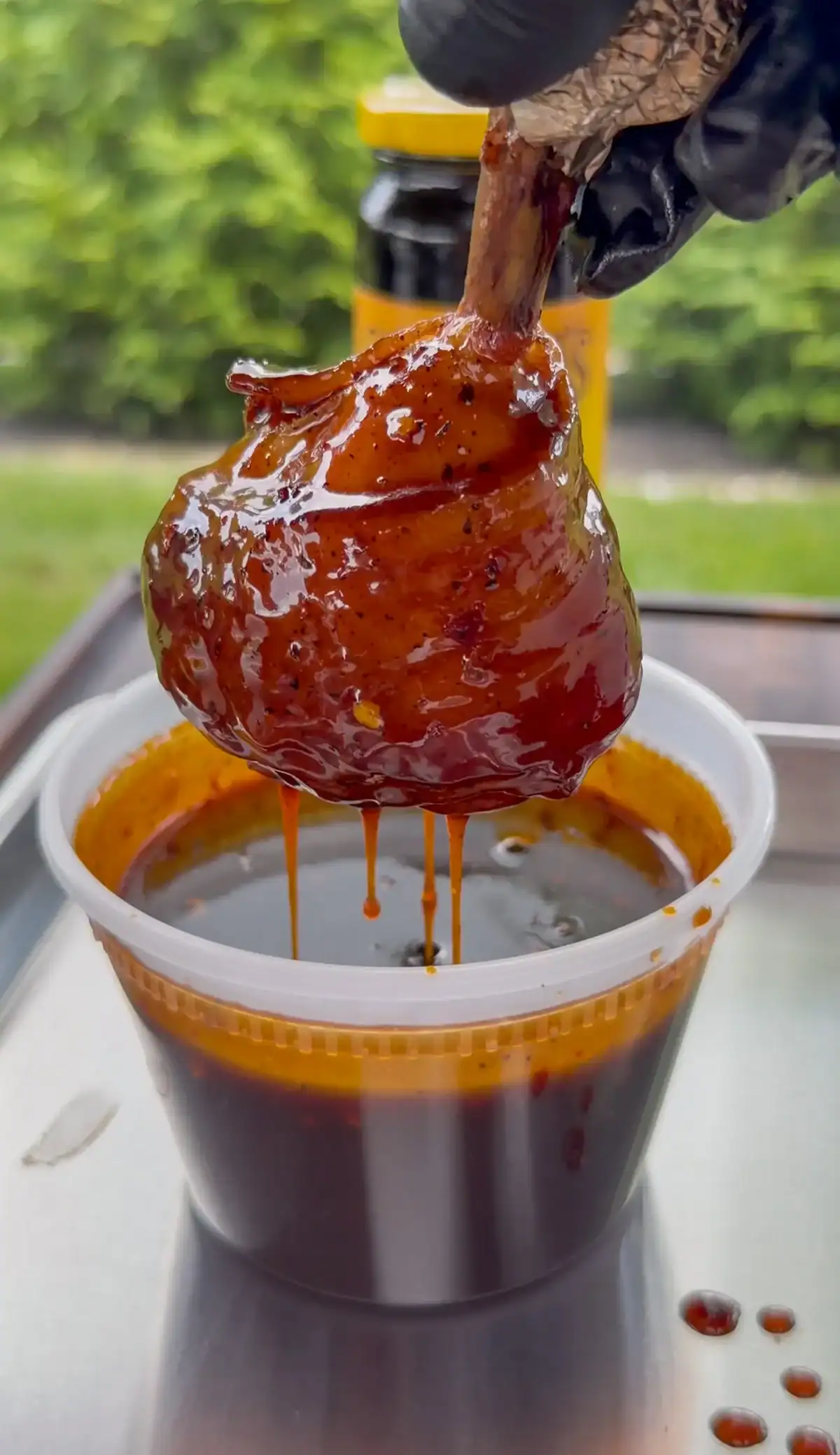 Bacon wrapped chicken lollipop dripped in molasses glaze