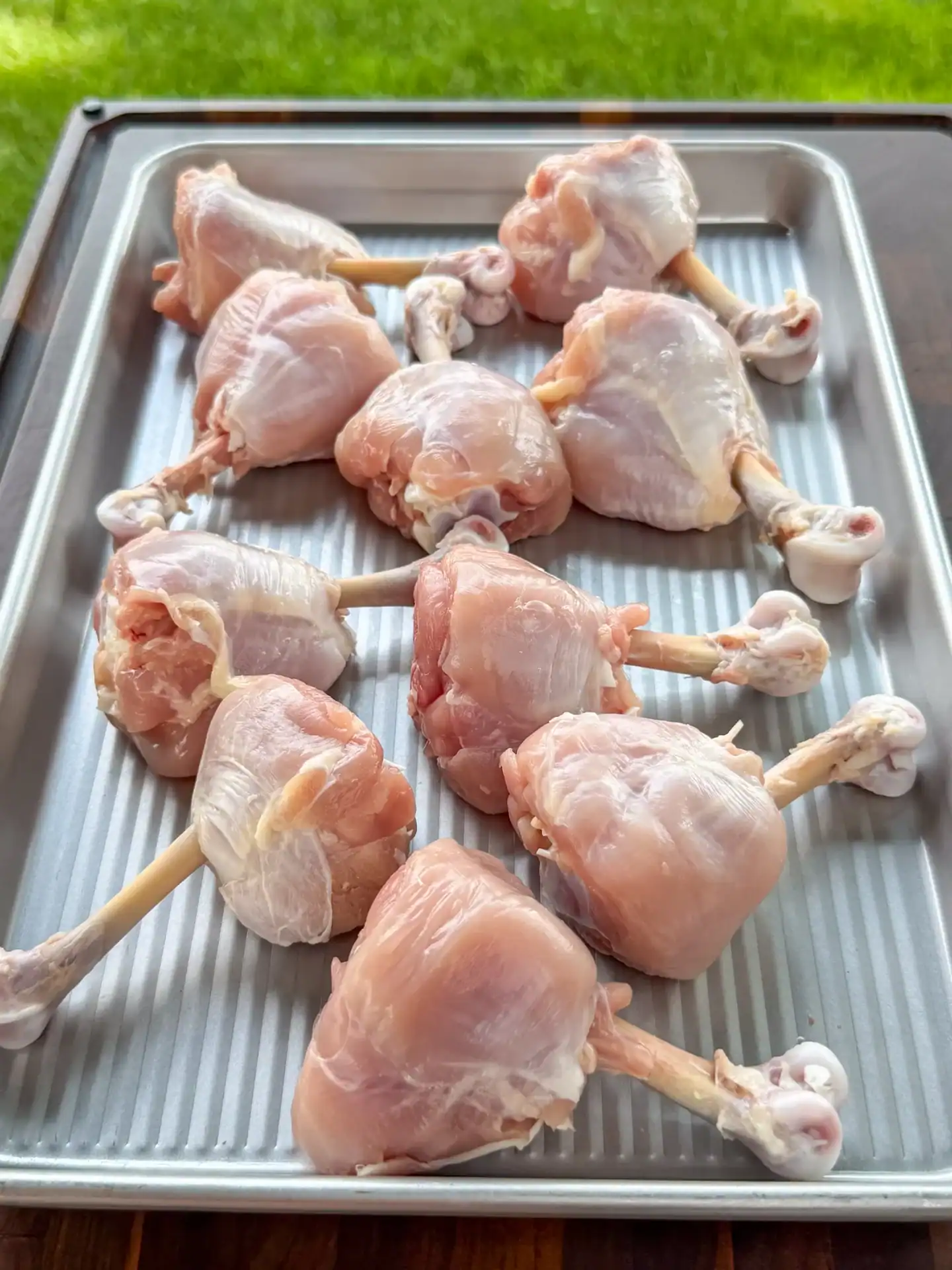 Skinless chicken drumsticks shaped into lollipops with exposed bones
