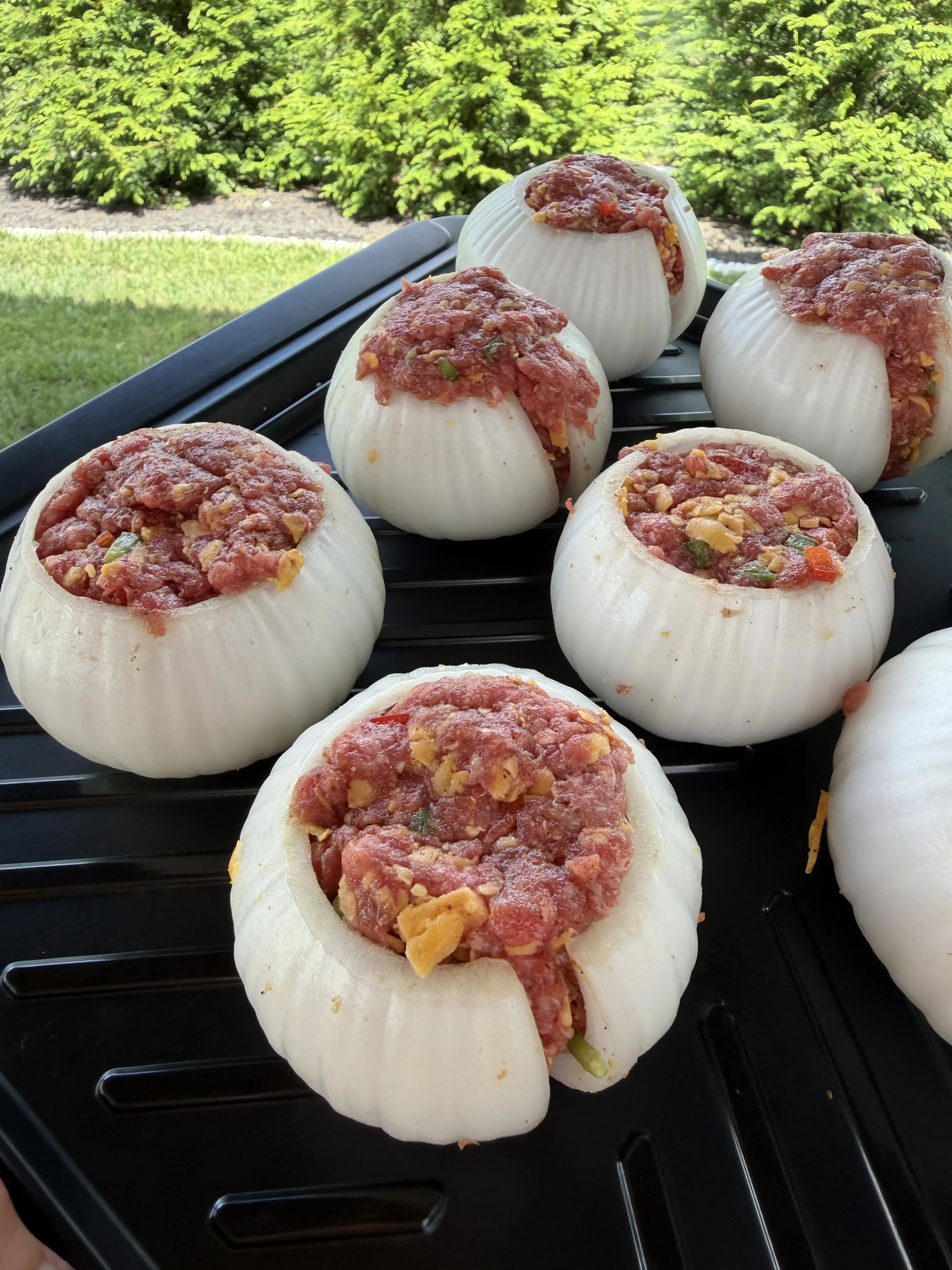 Sweet onions stuffed with raw cheeseburger filling and mounded over the top
