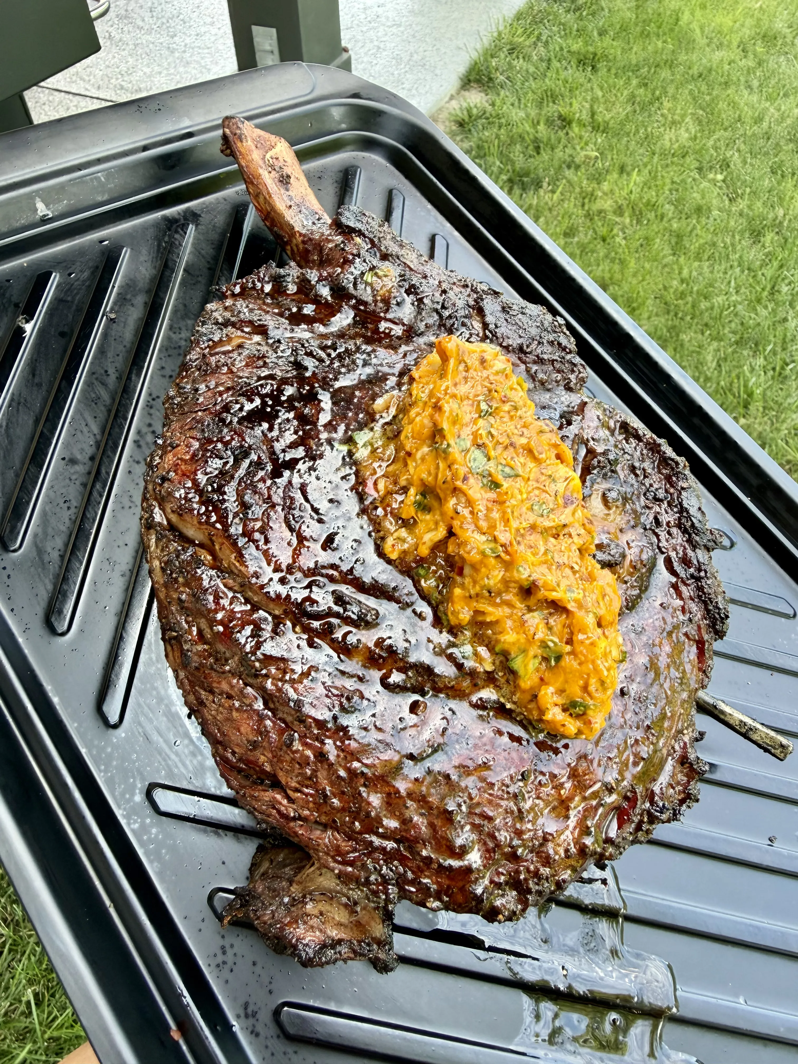 Smoked prime rib roast with chili parmesan compound butter melting over the top