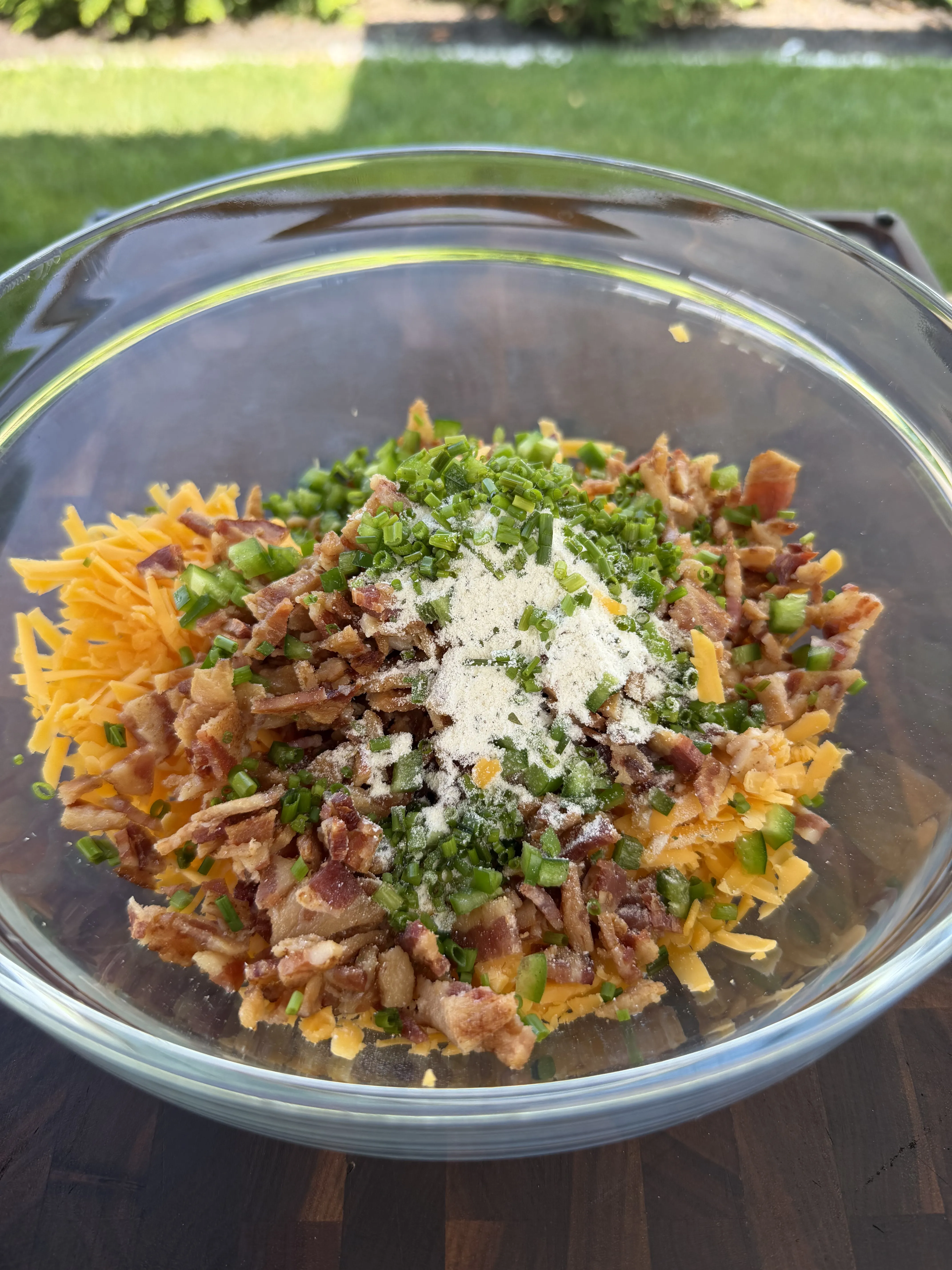 Shredded cheddar, bacon, jalapenos, and chives mixed for the burger stuffing