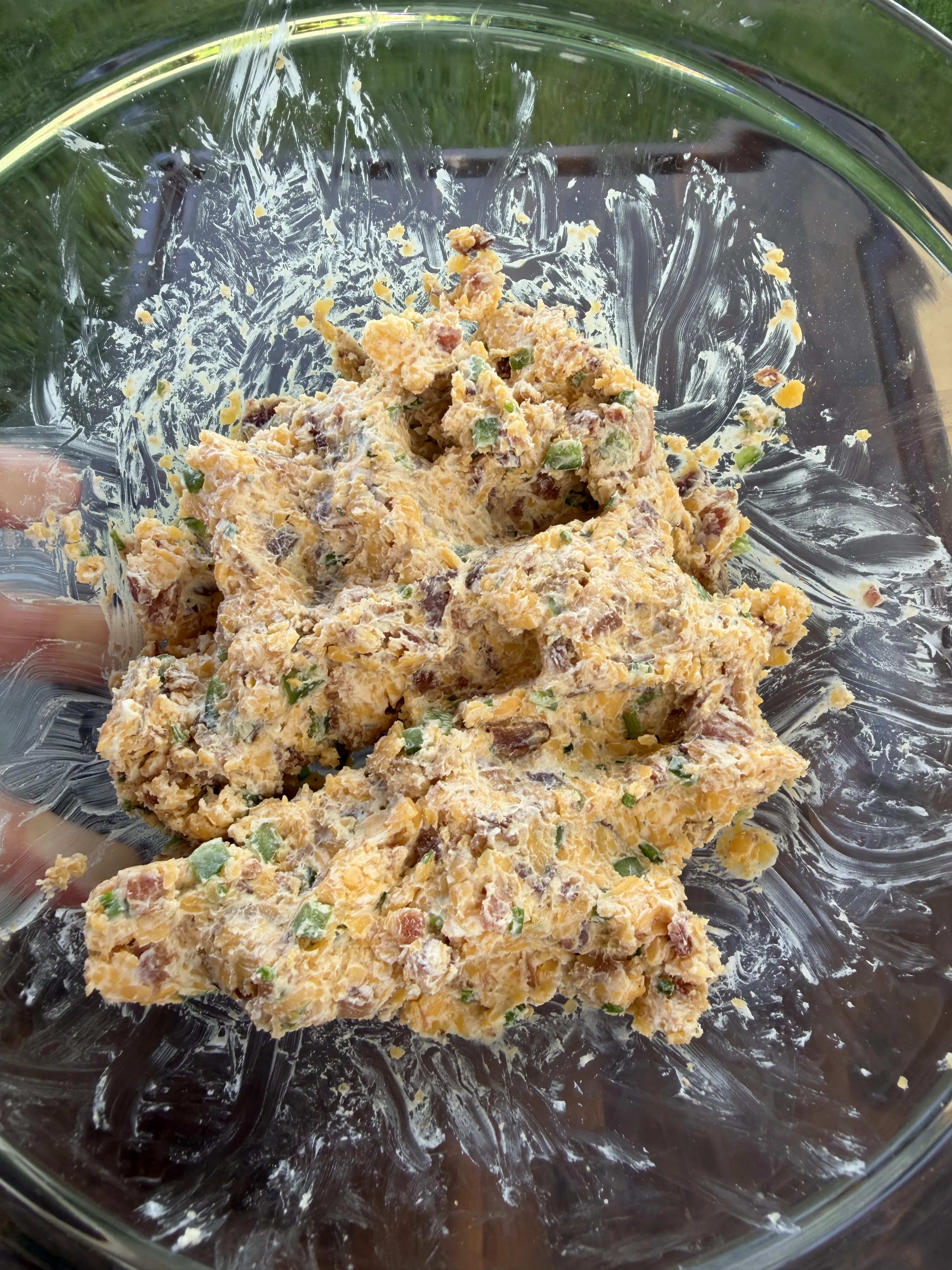 Cheesy bacon ranch stuffing mixture with cream cheese and chives in a glass bowl