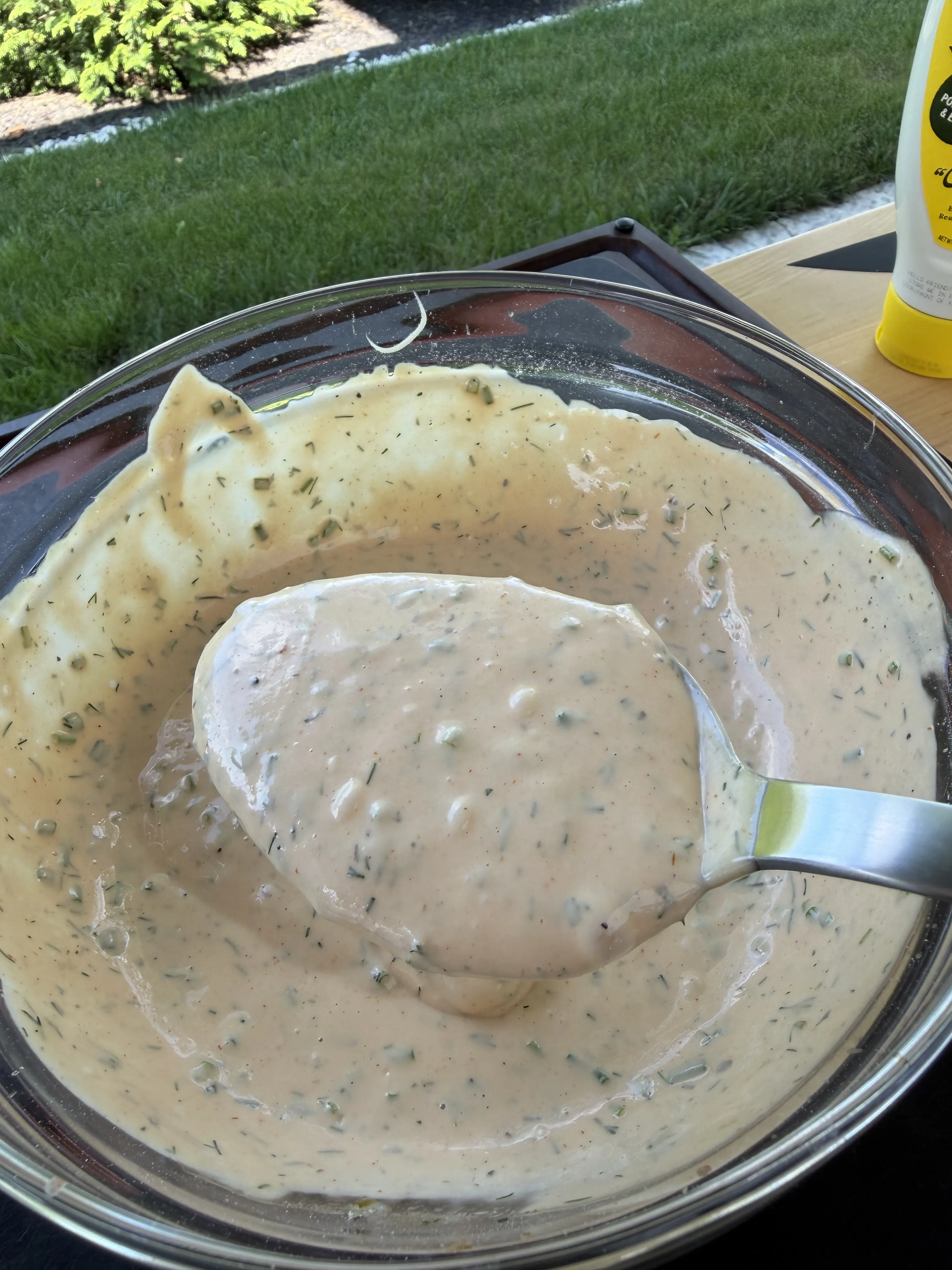 Whisked creamy burger sauce with dill ready to chill