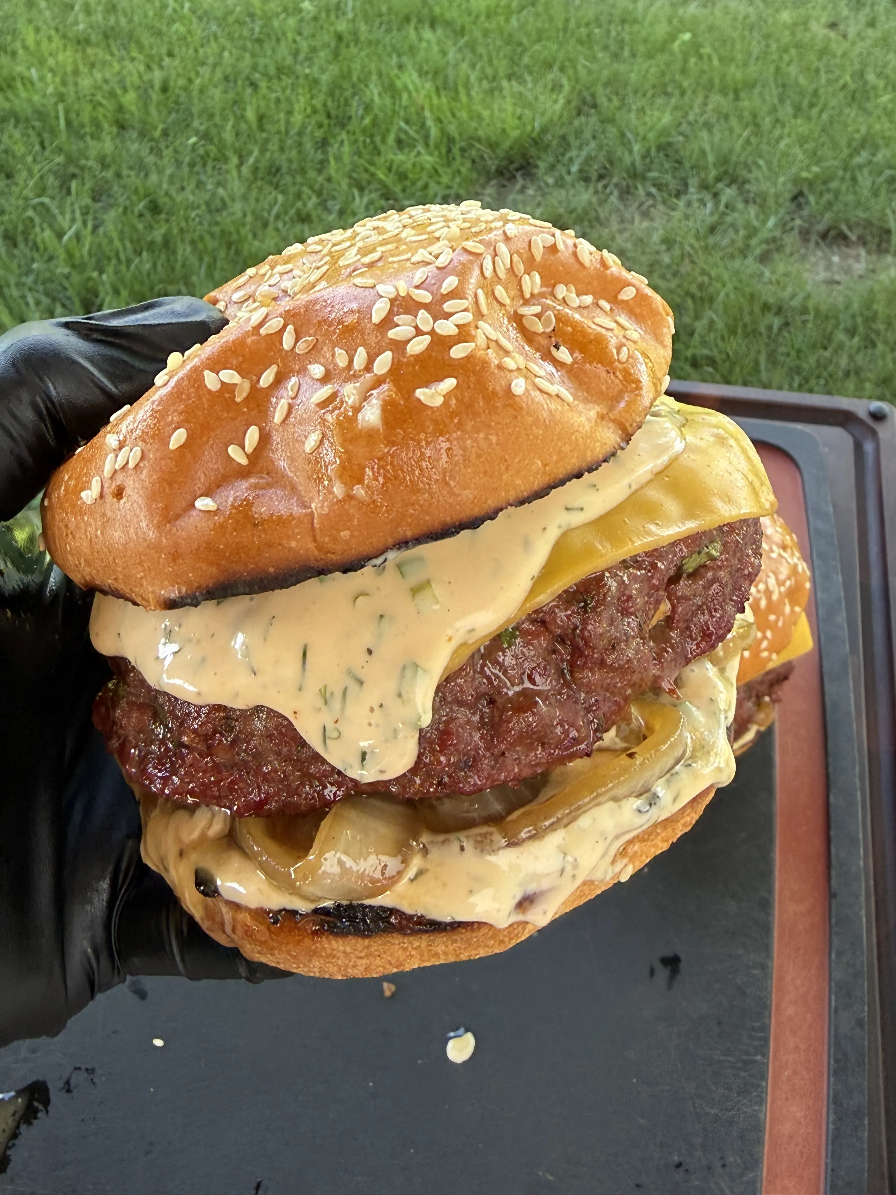 Finished smoked bacon ranch stuffed burger stacked tall on a toasted brioche bun