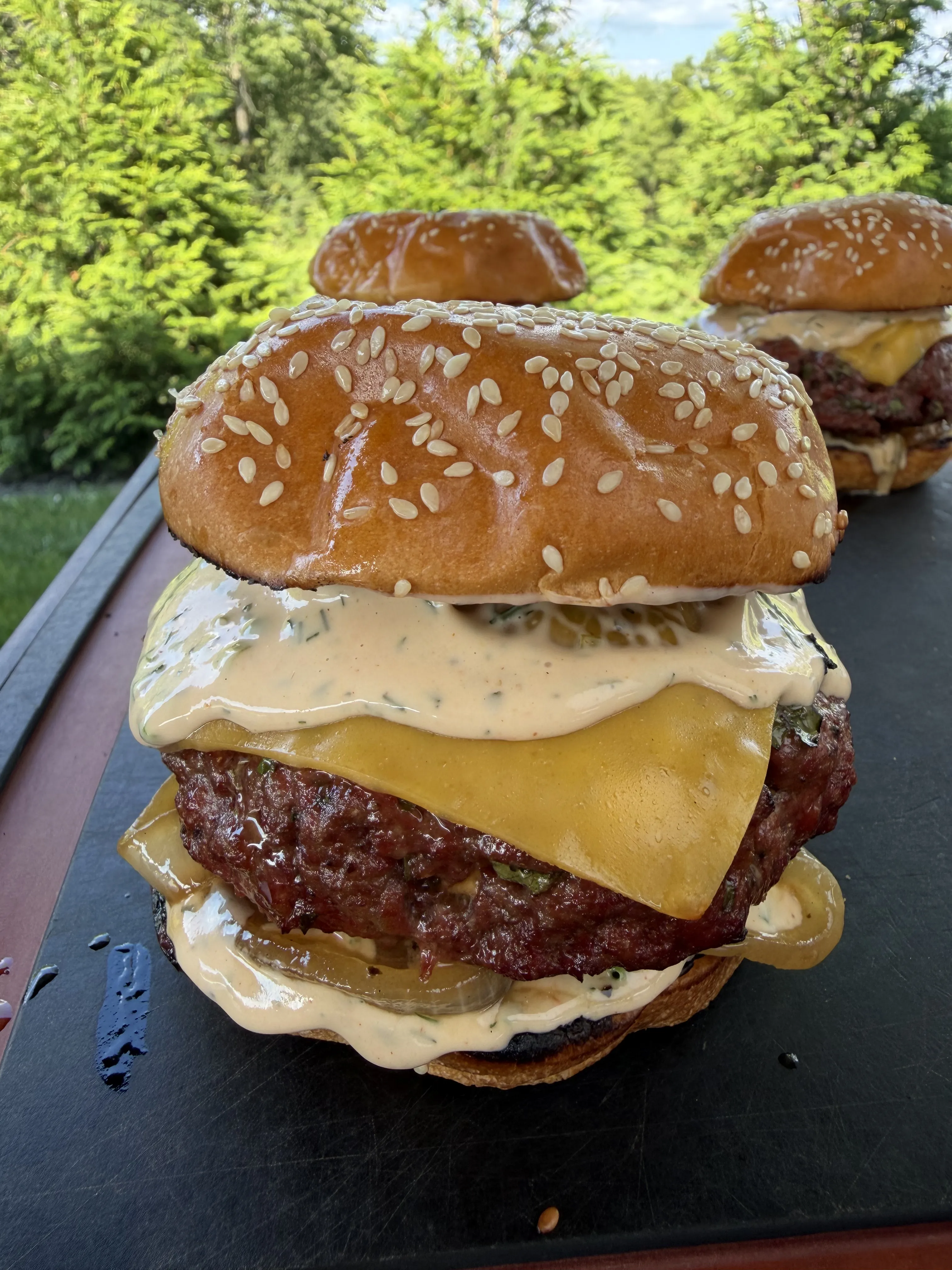 Juicy smoked bacon ranch stuffed burger with melted cheddar and creamy sauce