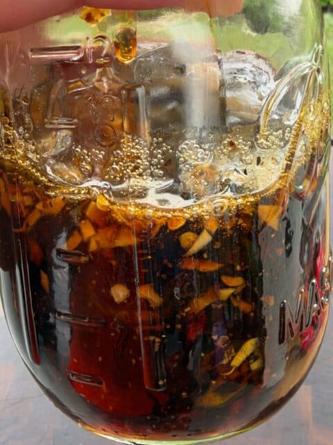 Smoked cowboy candy jalapeños and glaze stored in a glass jar