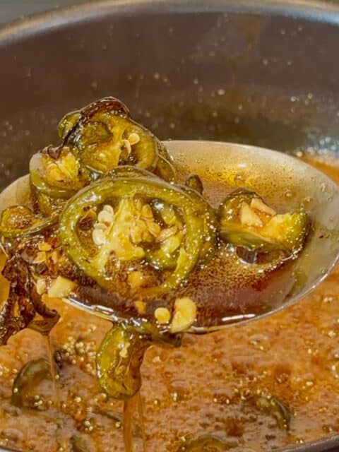 Smoked cowboy candy jalapeños coated in a thick apricot glaze