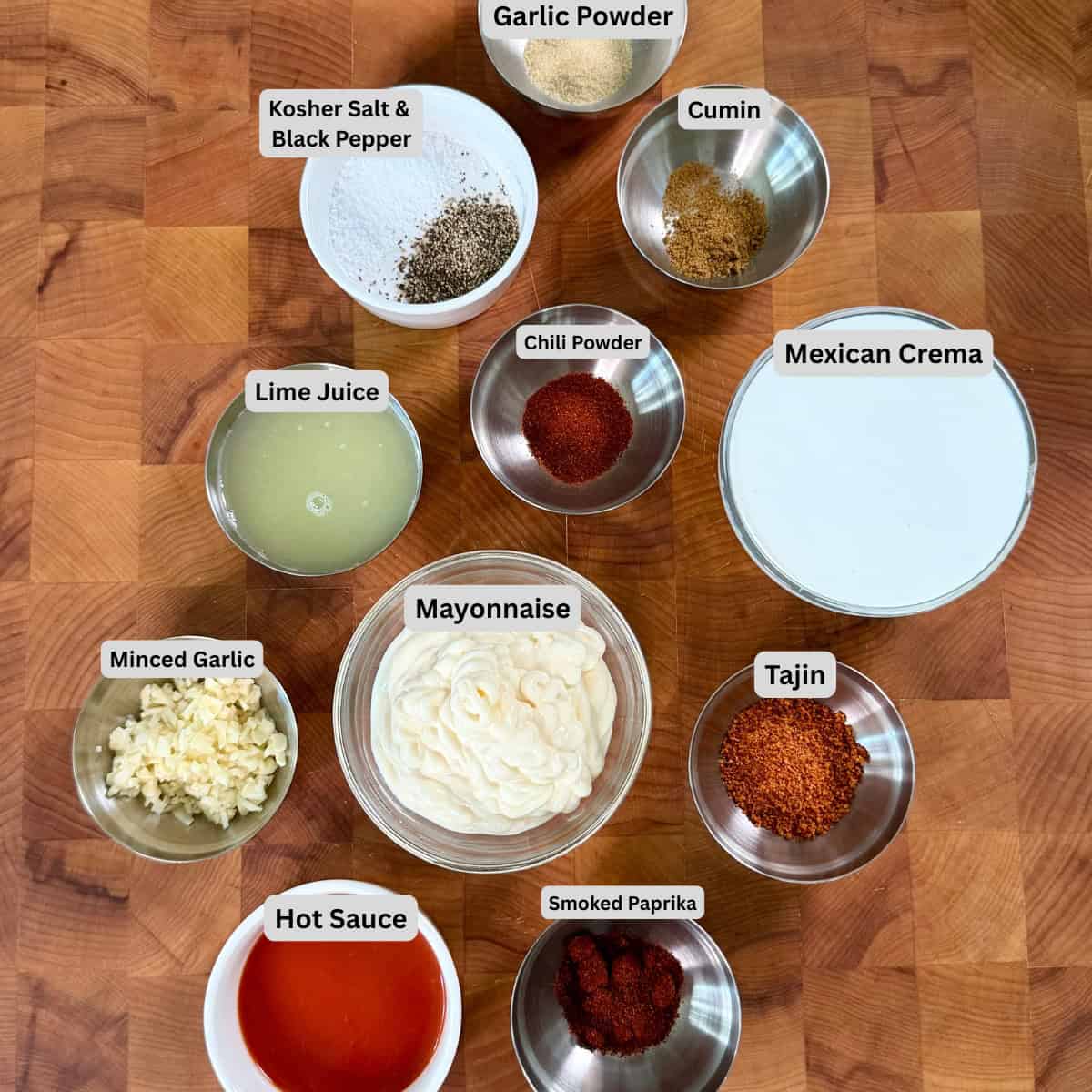 Mexican street corn crema ingredients with Mexican crema, mayonnaise, lime juice, Tajin, garlic, chili powder, and cumin