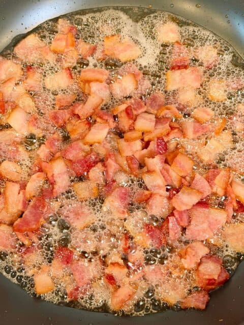 Diced bacon cooking until crispy for Chicken Bacon Ranch Pasta Salad