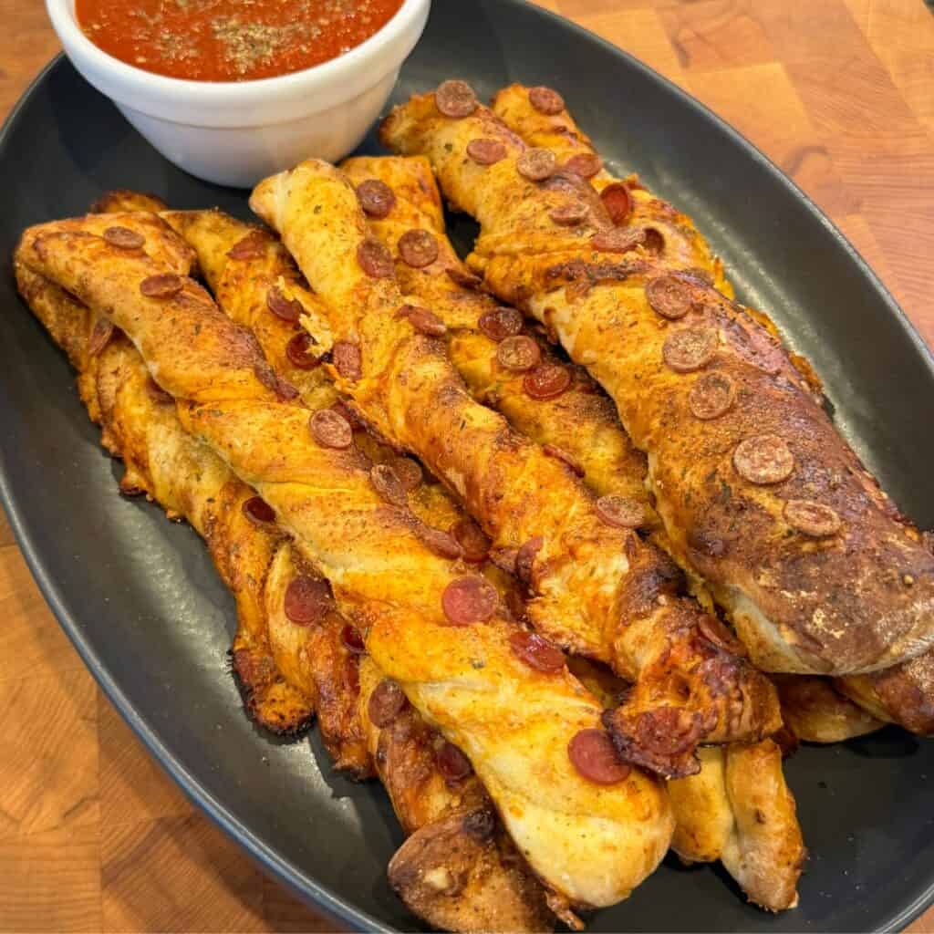 Pellet smoked pizza breadsticks with pepperoni, mozzarella, and garlic Parmesan butter