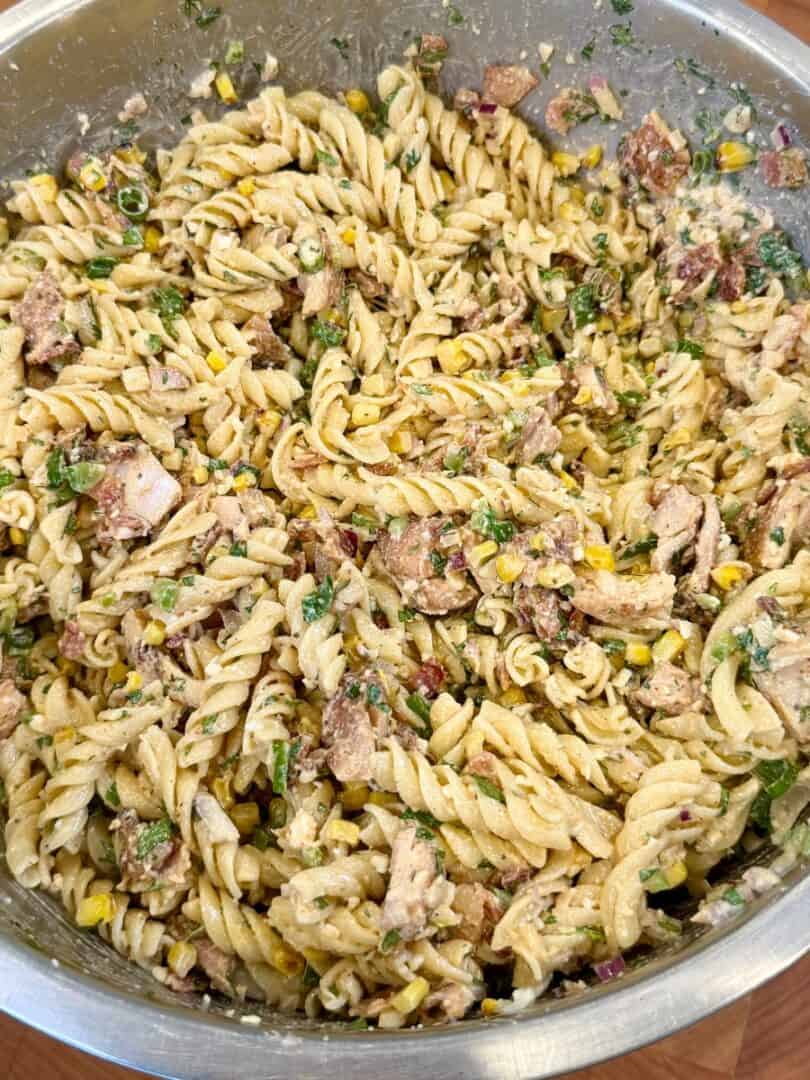 Mexican street corn pasta salad with grilled chicken, corn, cotija cheese, and creamy chili lime sauce