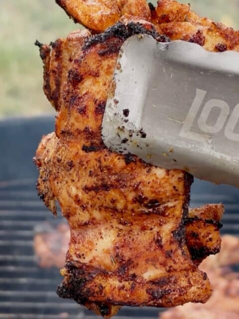 Cajun-seasoned chicken thighs grilling for Chicken Bacon Ranch Pasta Salad