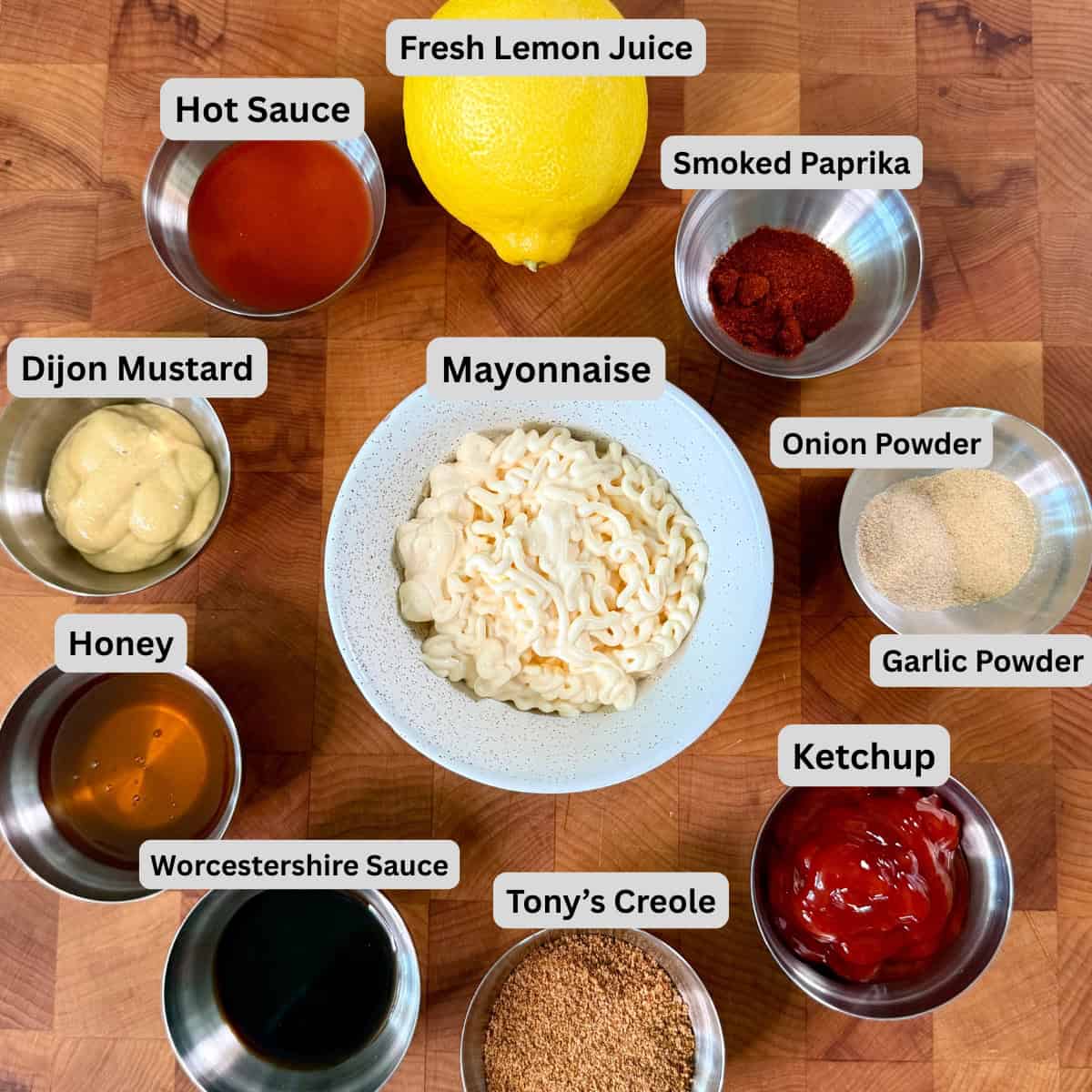 Ingredients for Cajun comeback sauce with mayonnaise, ketchup, Dijon mustard, hot sauce, Worcestershire, lemon, honey, and Creole seasoning