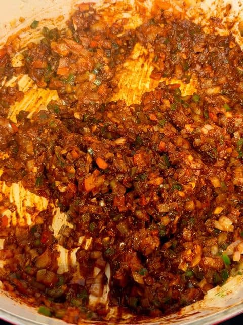 Sautéed vegetables with tomato paste, Worcestershire sauce, and adobo sauce for Smoked Over the Top Chili.