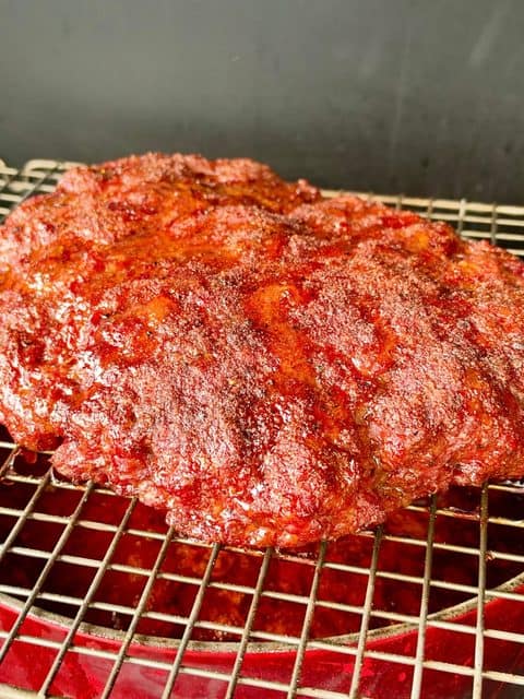 BBQ-seasoned ground chuck and Italian sausage smoking over a Dutch oven of chili at 275°F.